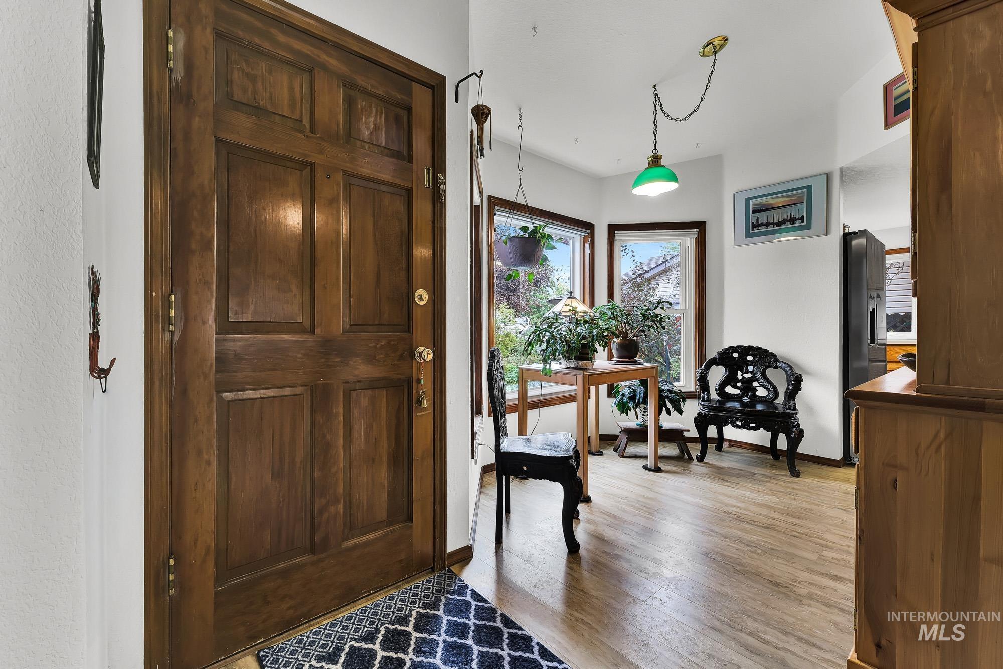 Foyer featuring light wood-style floors and baseboards