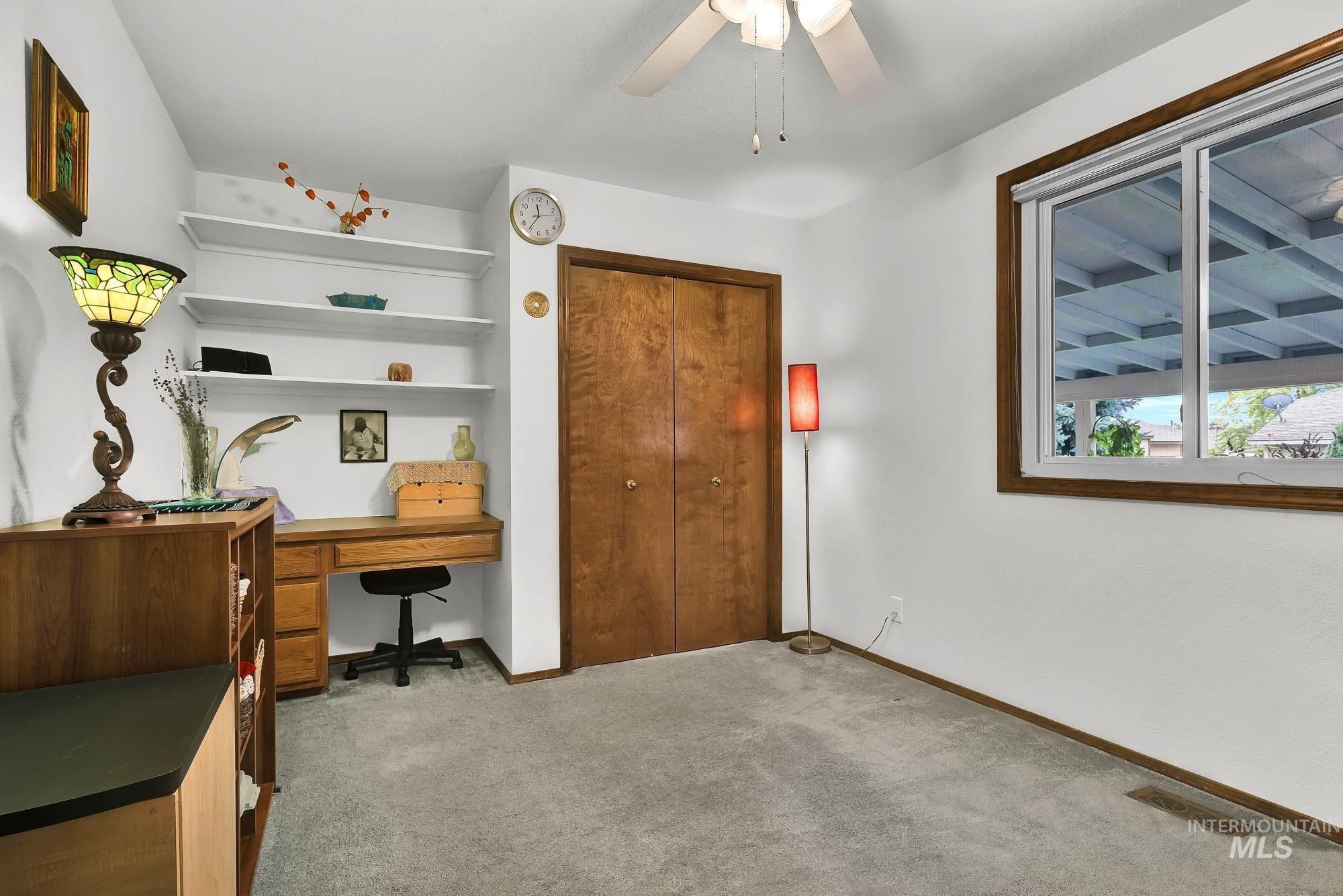 Office space featuring carpet floors and ceiling fan