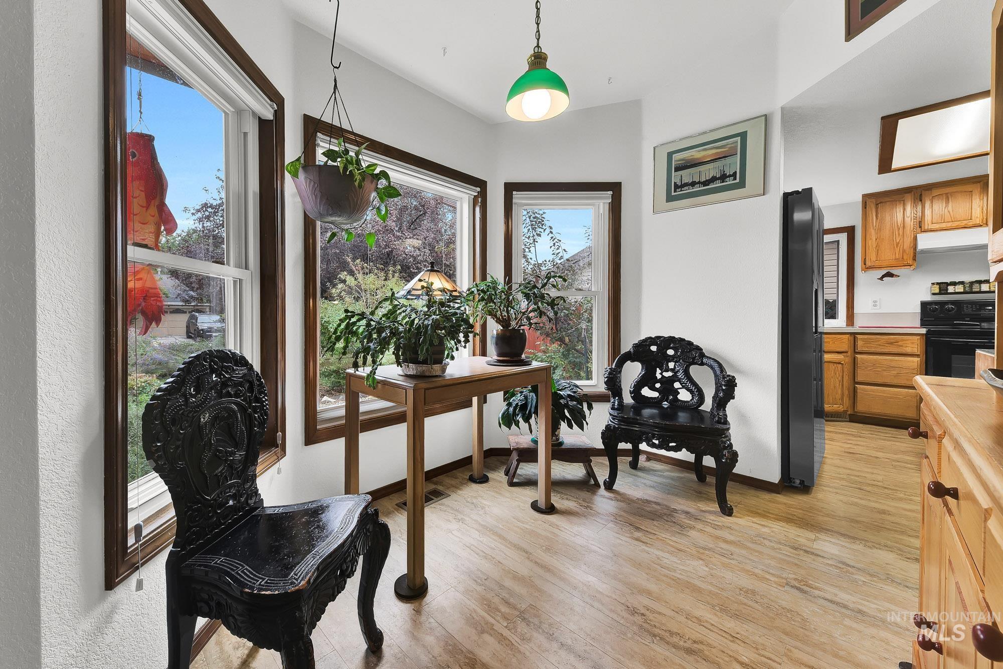 Living area featuring light wood-type flooring and baseboards