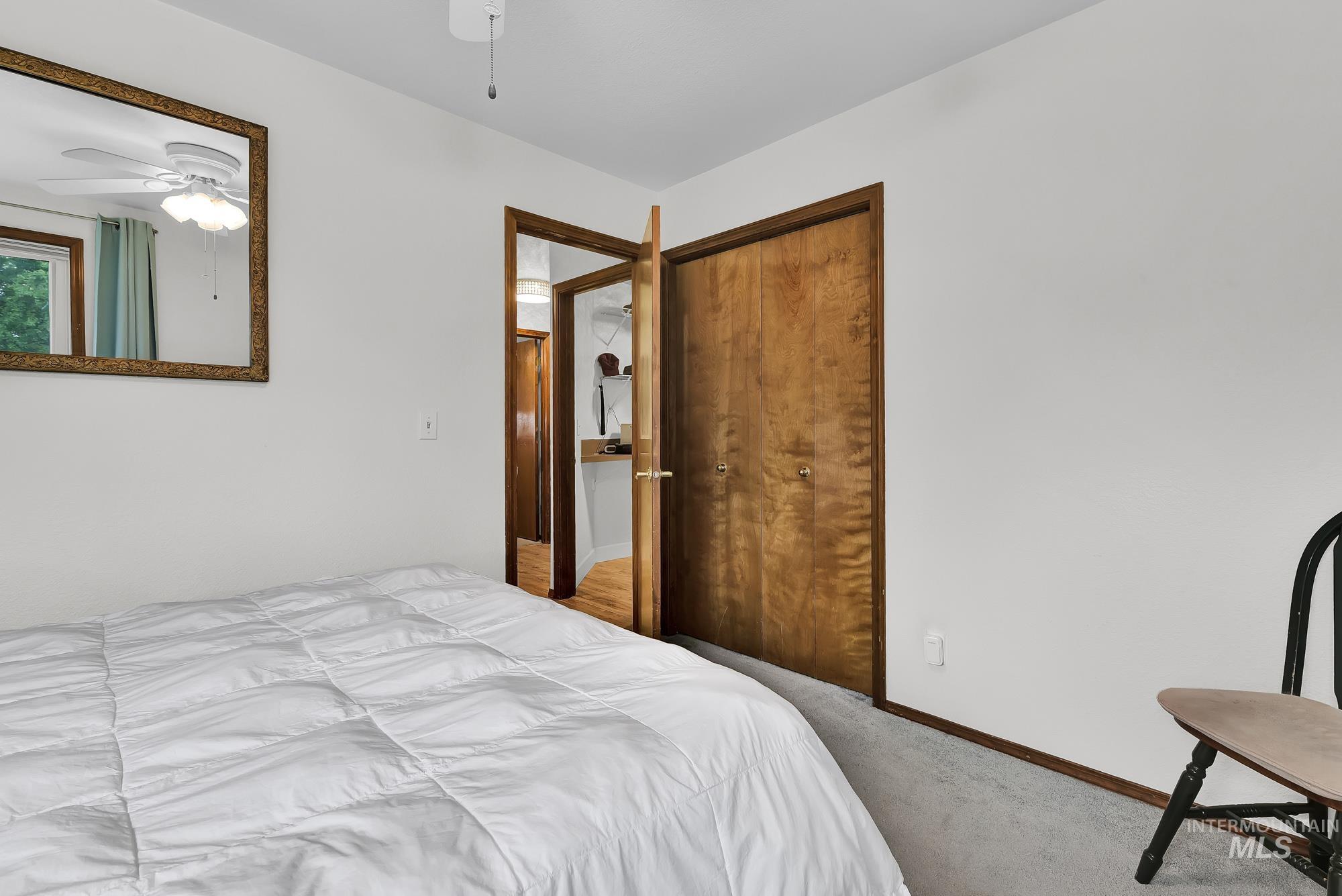 Carpeted bedroom with baseboards and a closet