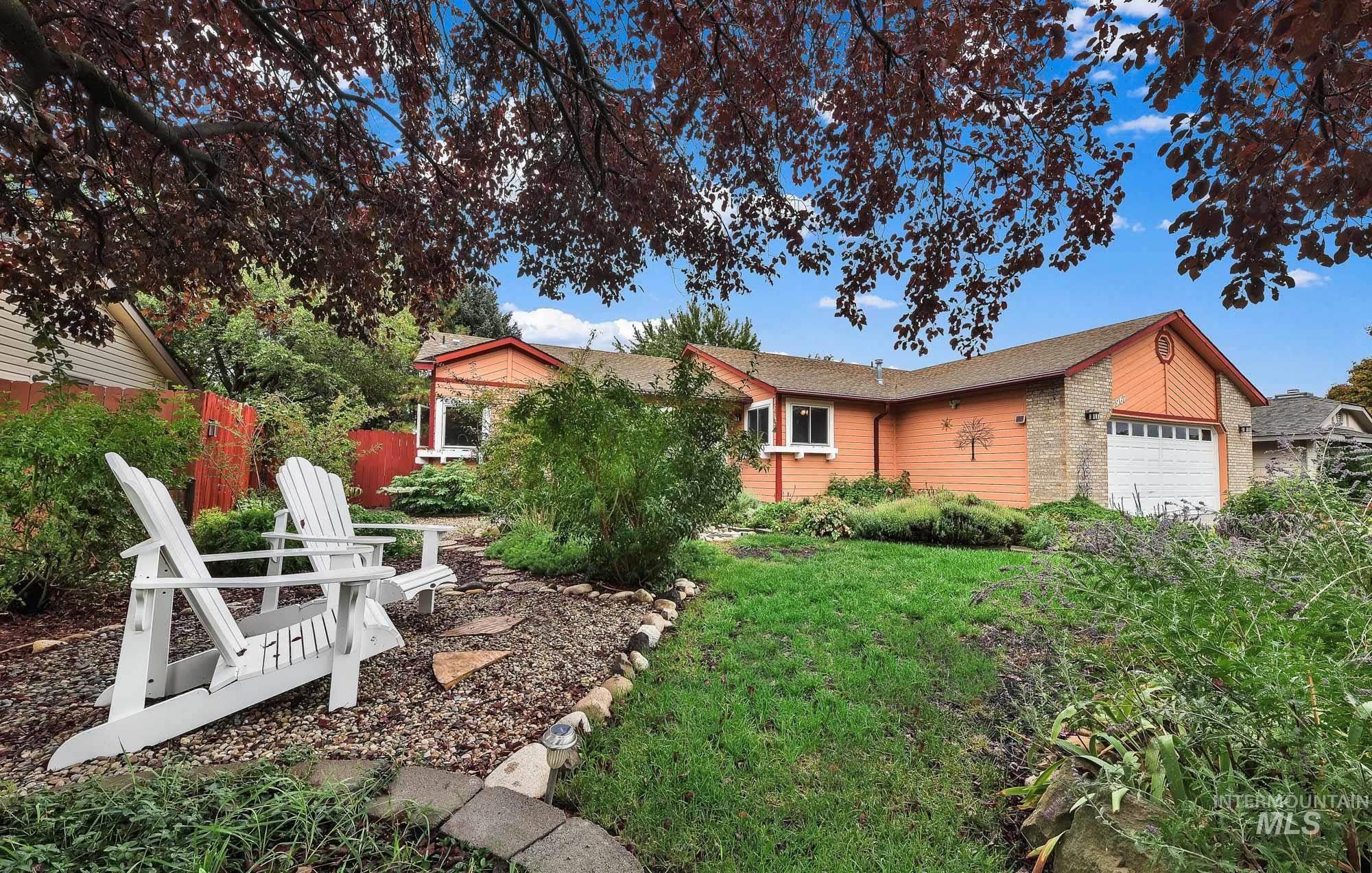 View of front of home featuring an attached garage, roof with shingles, and brick siding