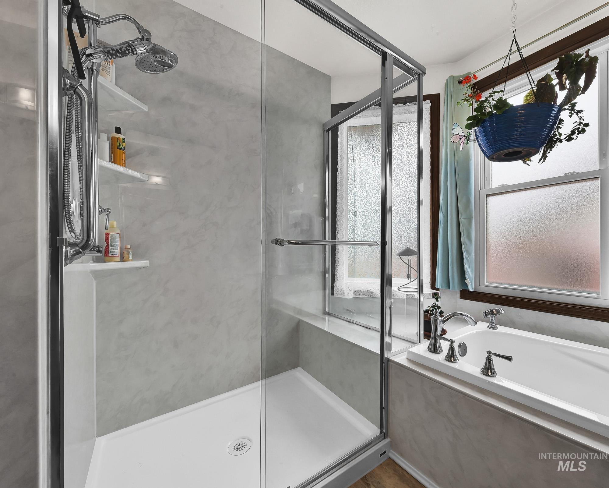 Full bath with a stall shower and a bath