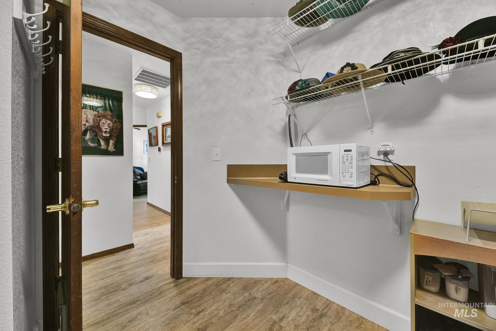 Washroom featuring light wood-style floors and baseboards