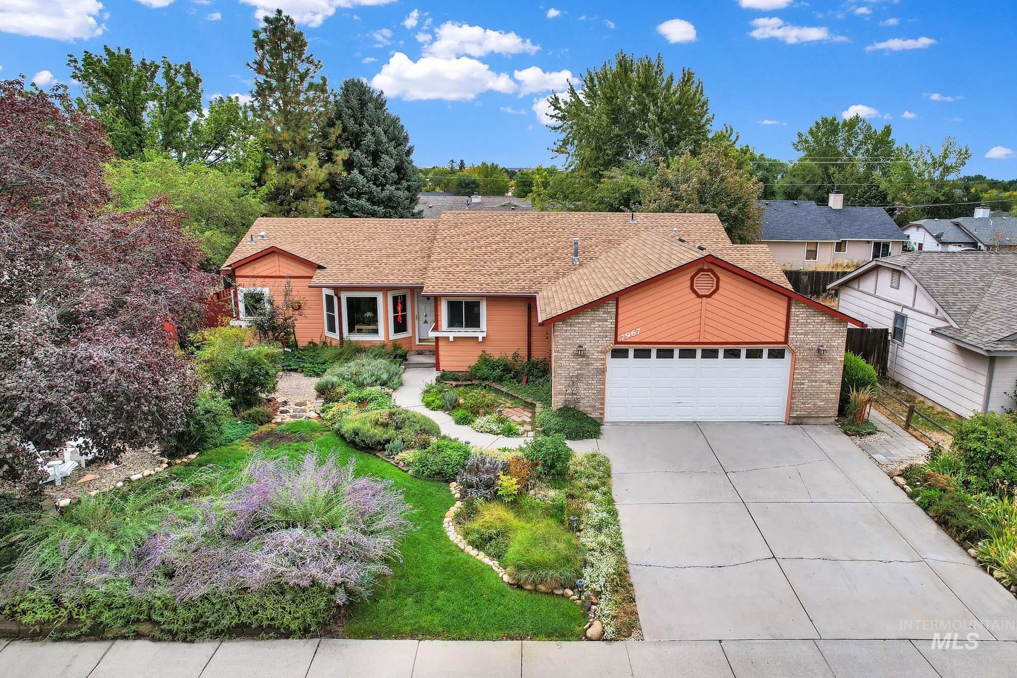 View of front of home with an attached garage, concrete driveway, and roof with shingles