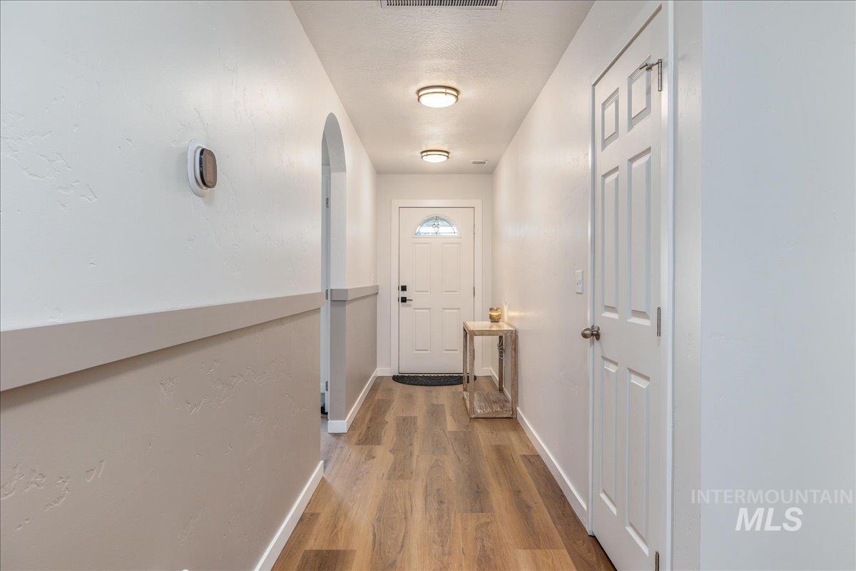 Entryway featuring wood finished floors and a textured ceiling