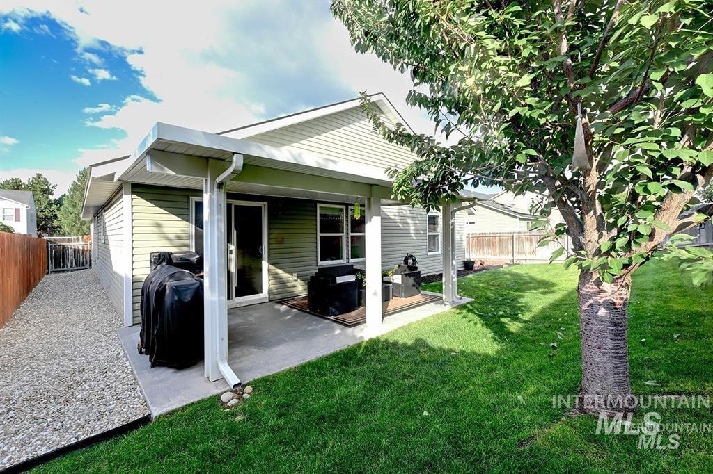 Back of property featuring a fenced backyard and a patio area