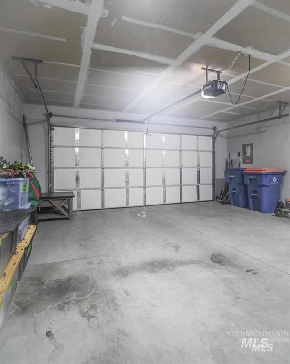 Garage with electric panel and a garage door opener