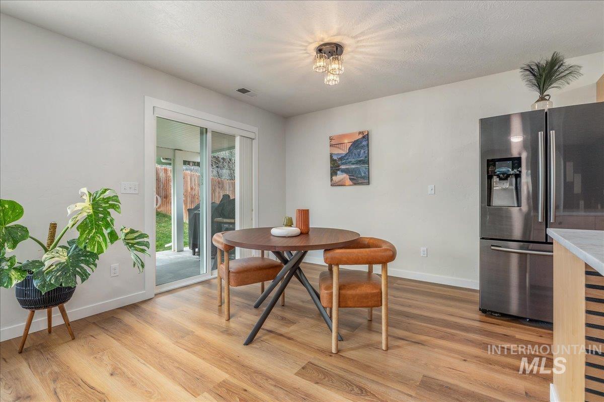 Dining area with light wood finished floors and baseboards