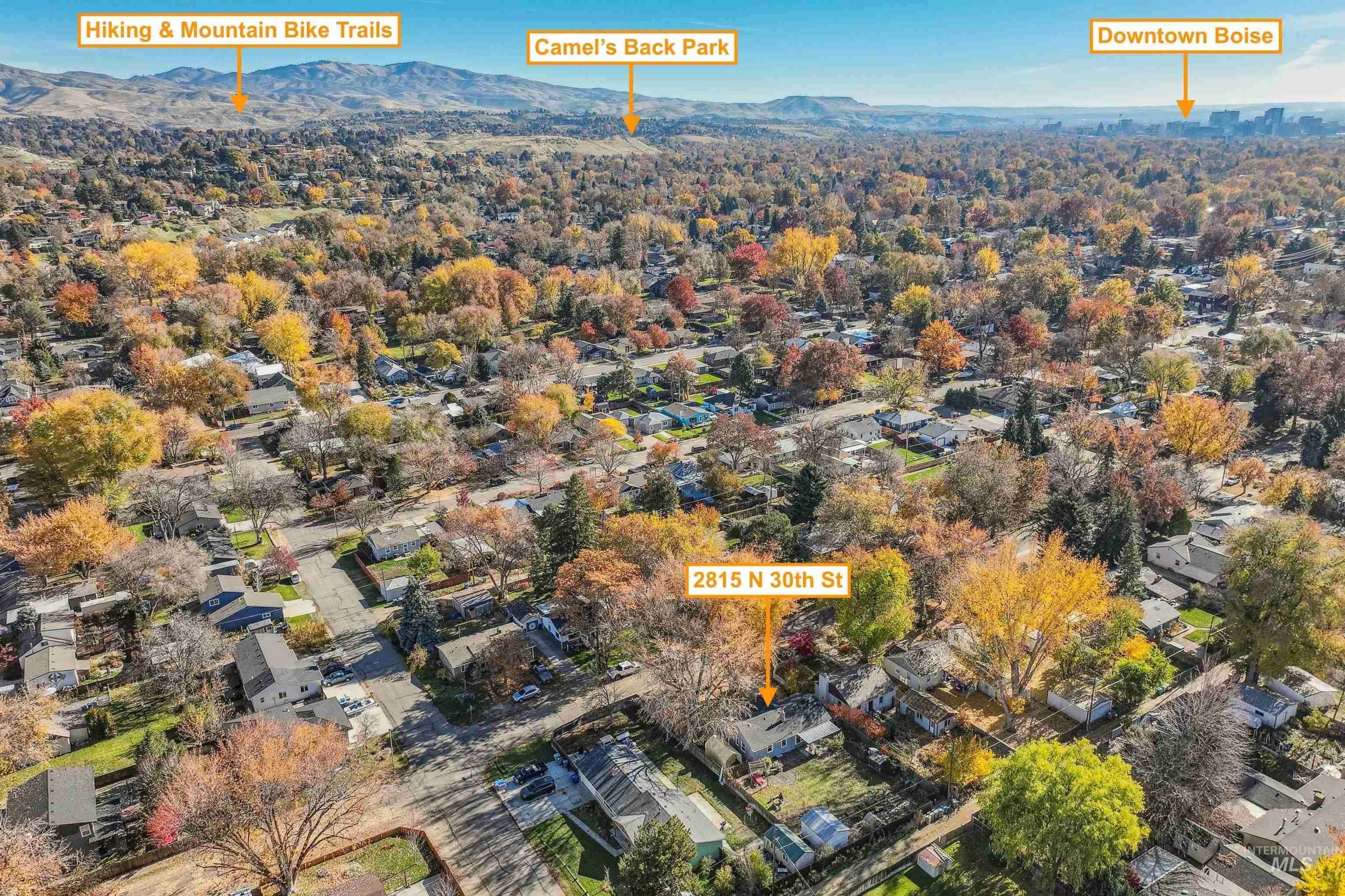 Aerial view of property's location featuring nearby suburban area and mountains