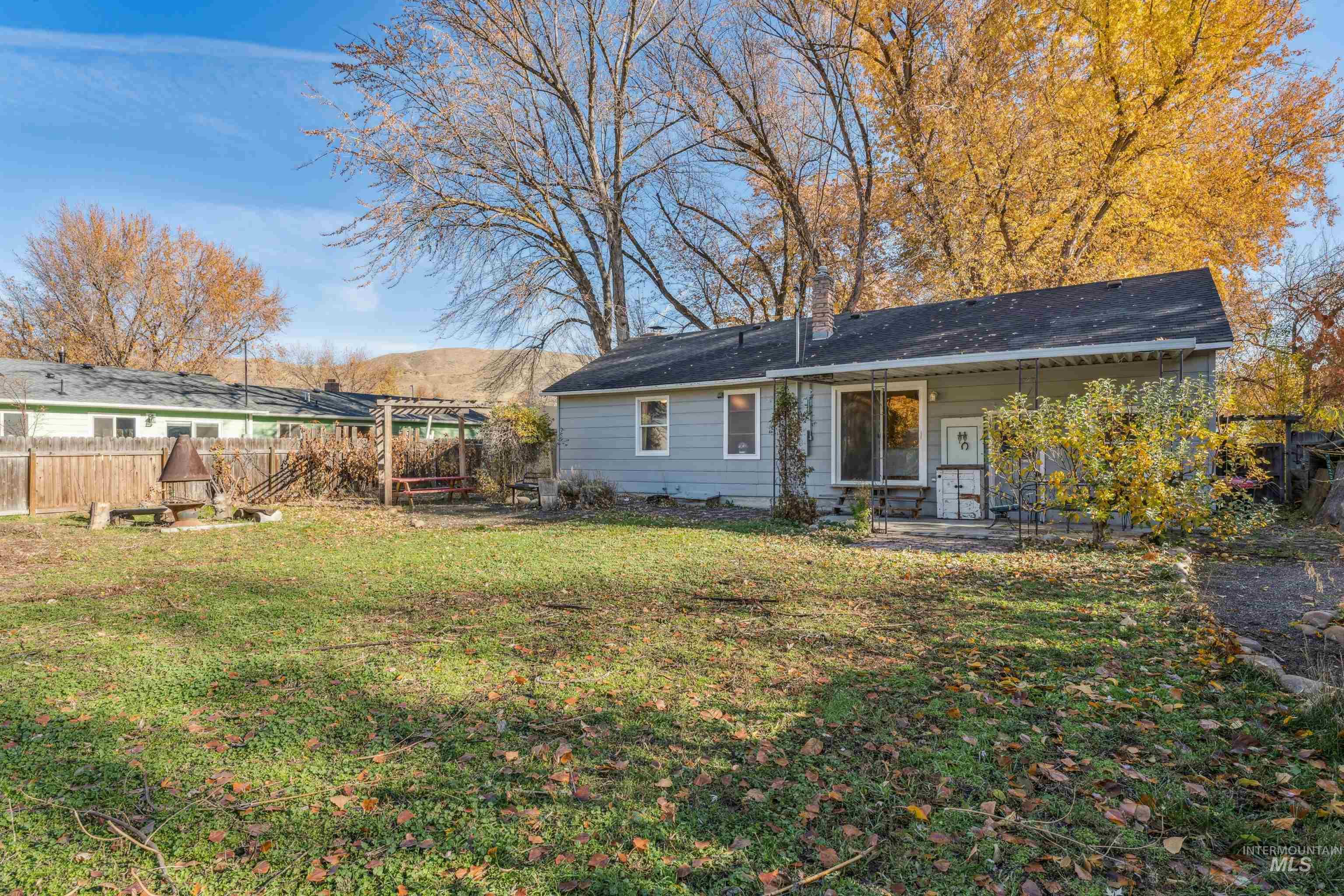 Back of property featuring a chimney and covered porch