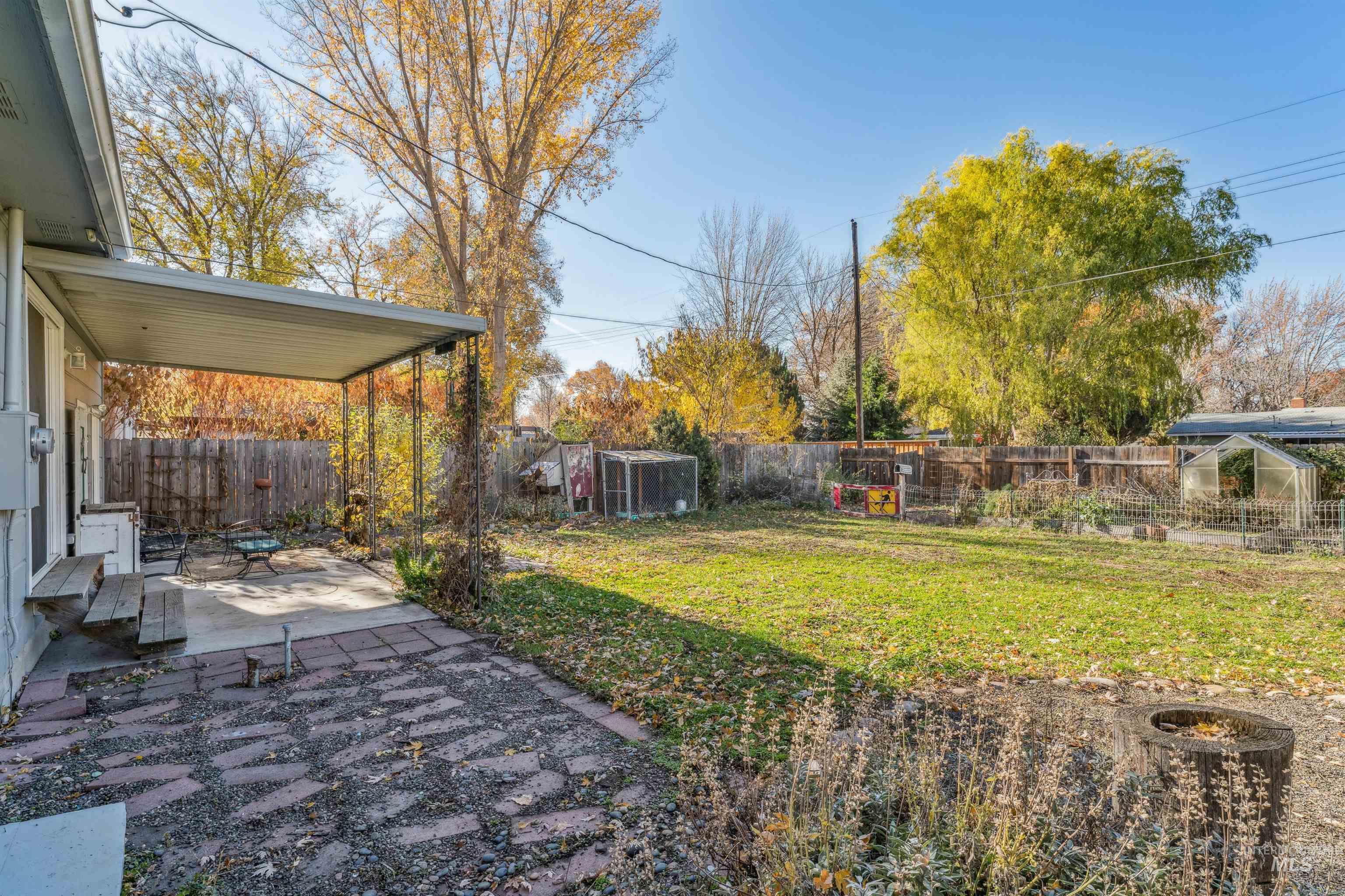 Fenced backyard with a patio, an outdoor structure, and an exterior structure