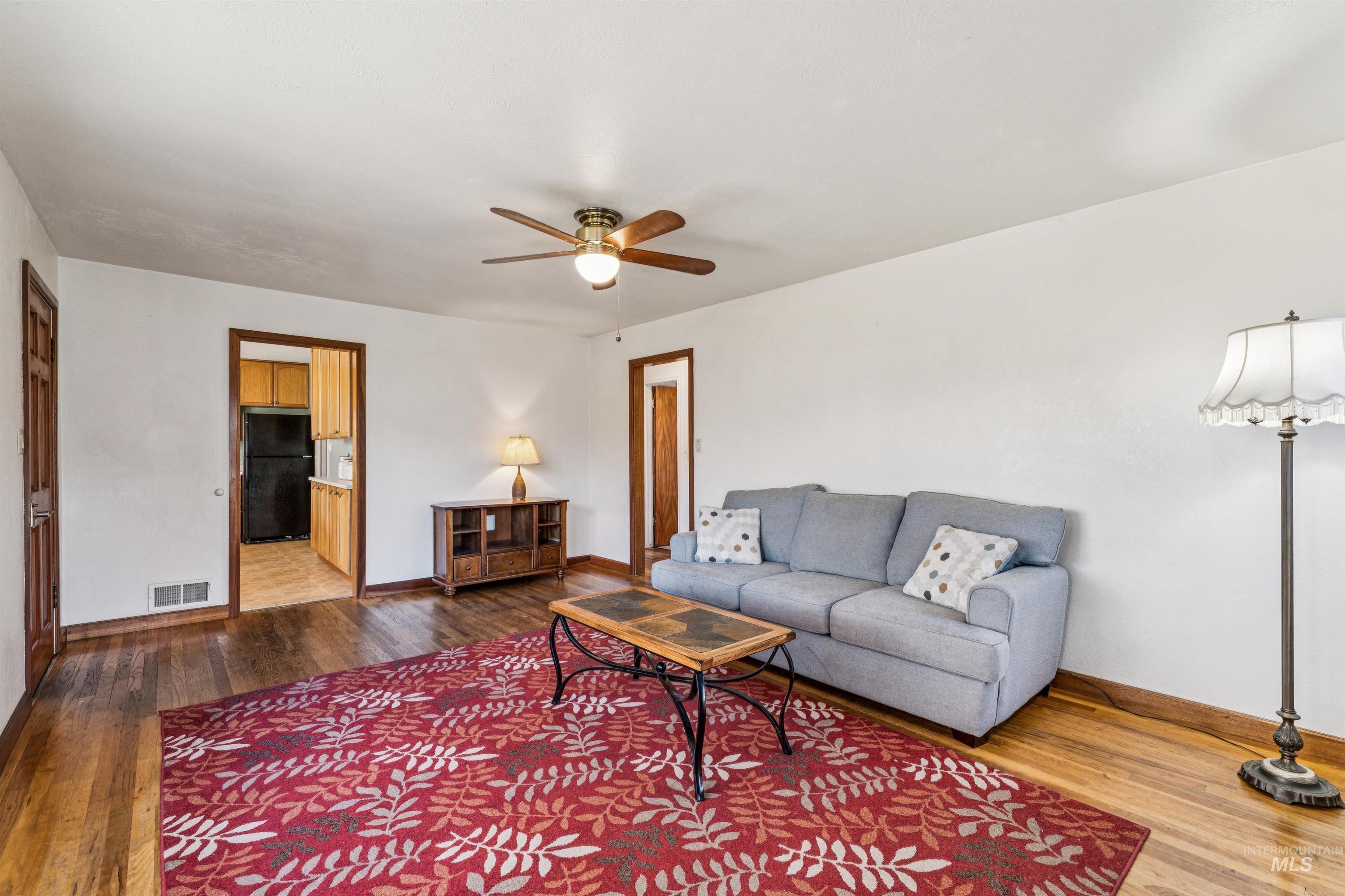 Living room featuring hardwood / wood-style floors and ceiling fan