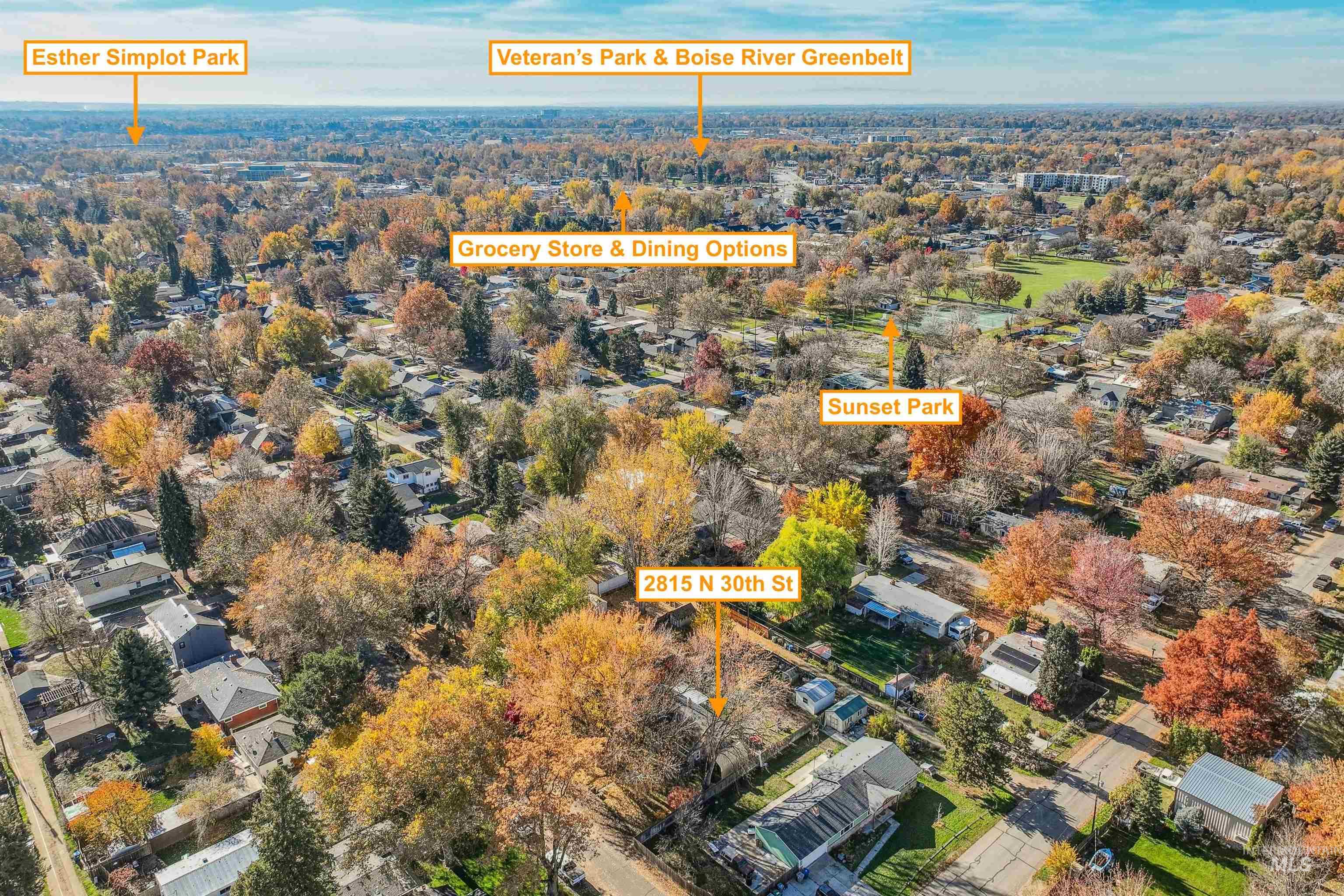 Aerial view of property and surrounding area featuring nearby suburban area