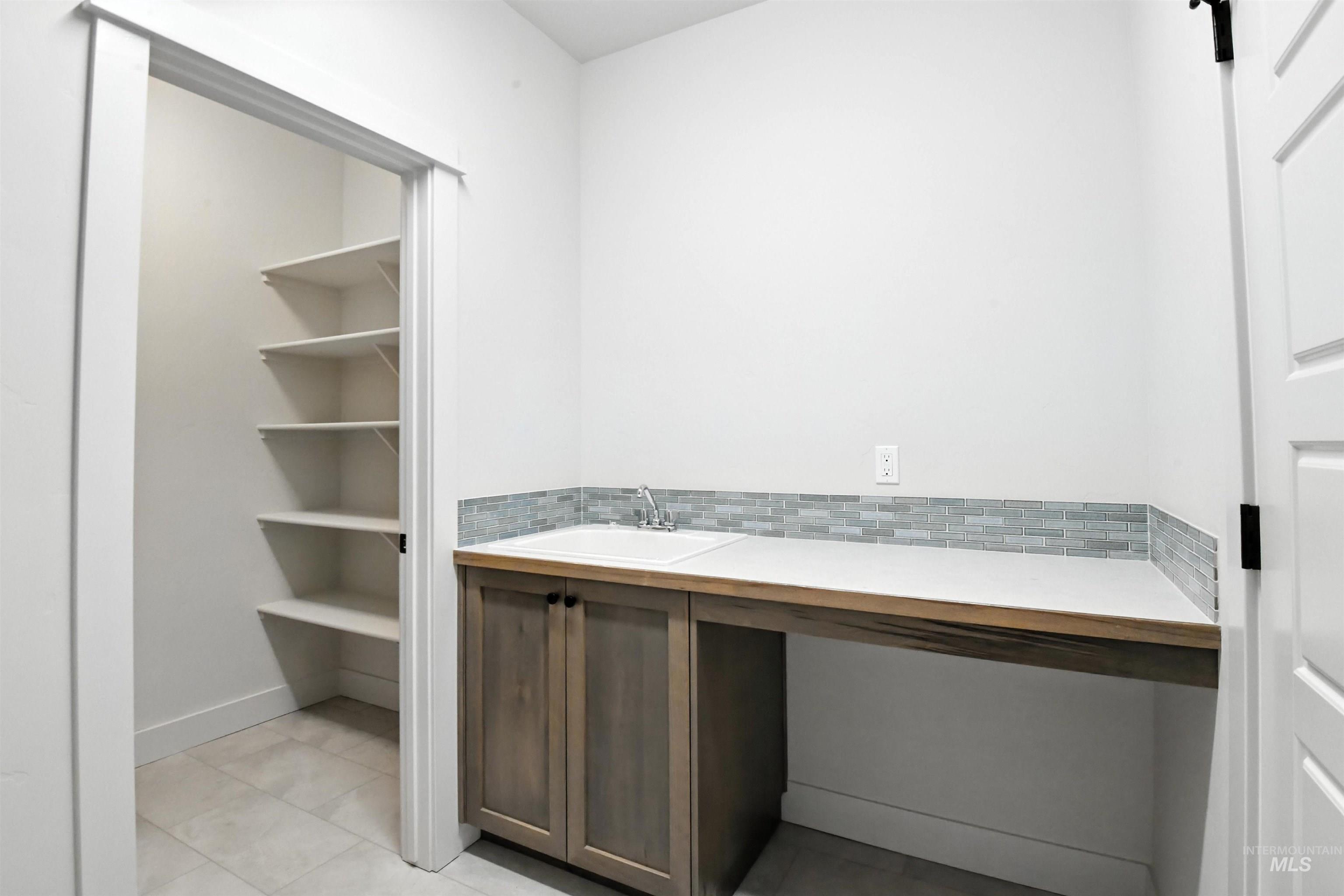 Bathroom with tile patterned floors and vanity