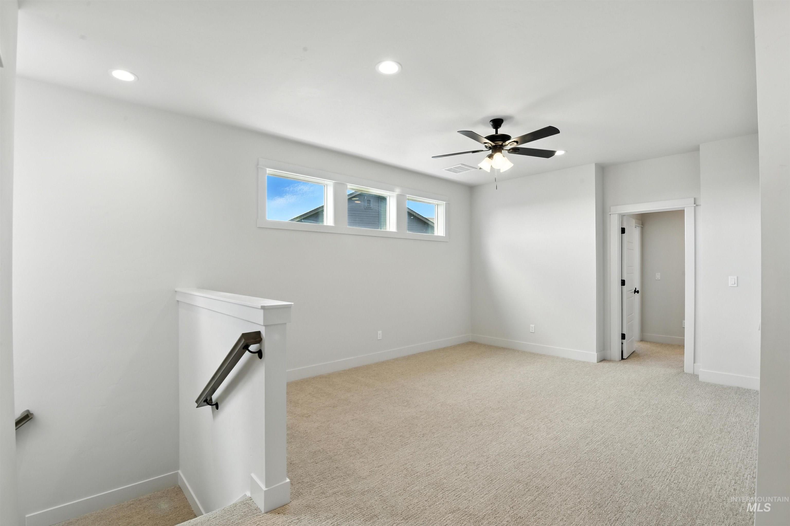 Unfurnished room with light colored carpet, recessed lighting, and a ceiling fan