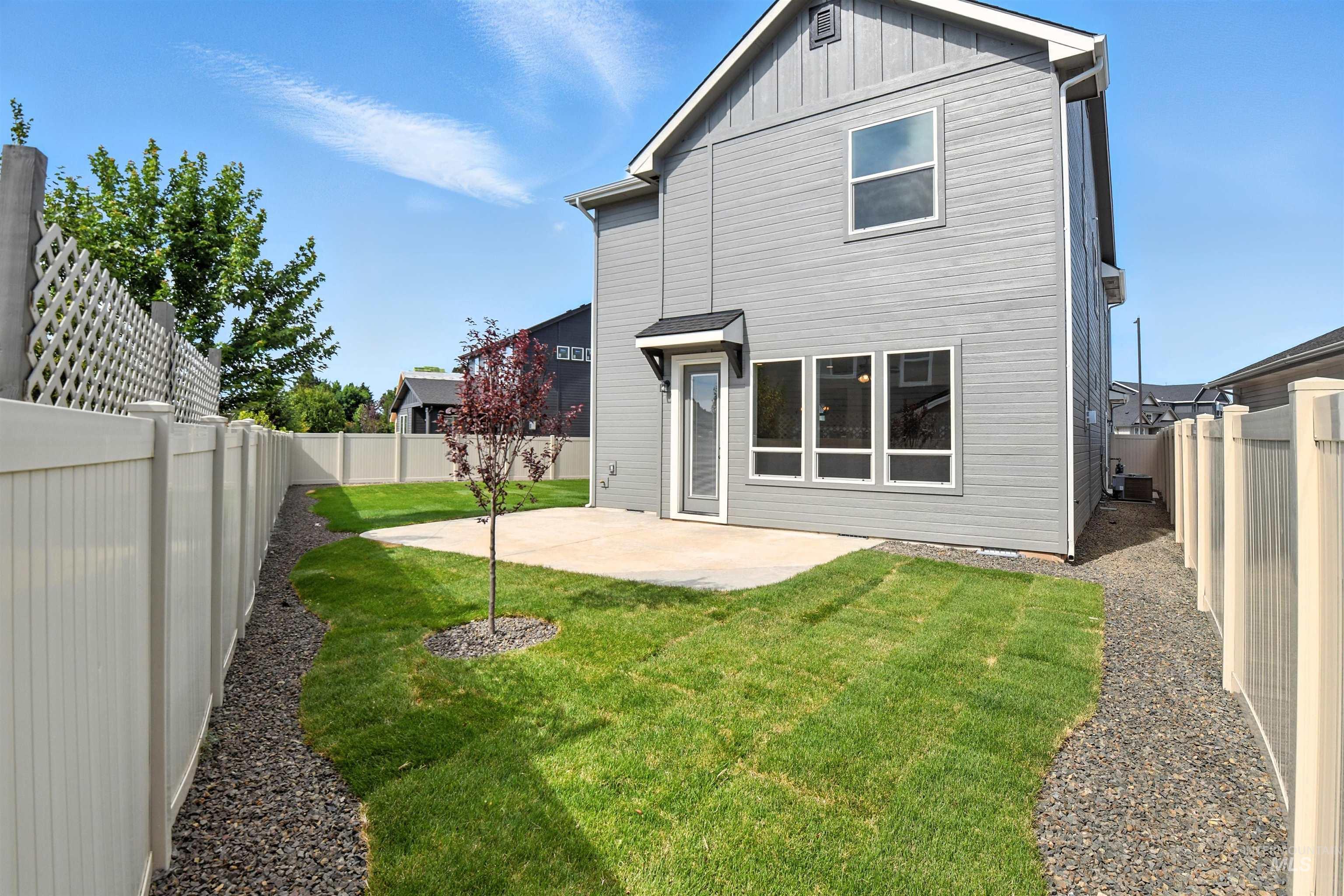 Back of house featuring a patio area, a fenced backyard, and board and batten siding