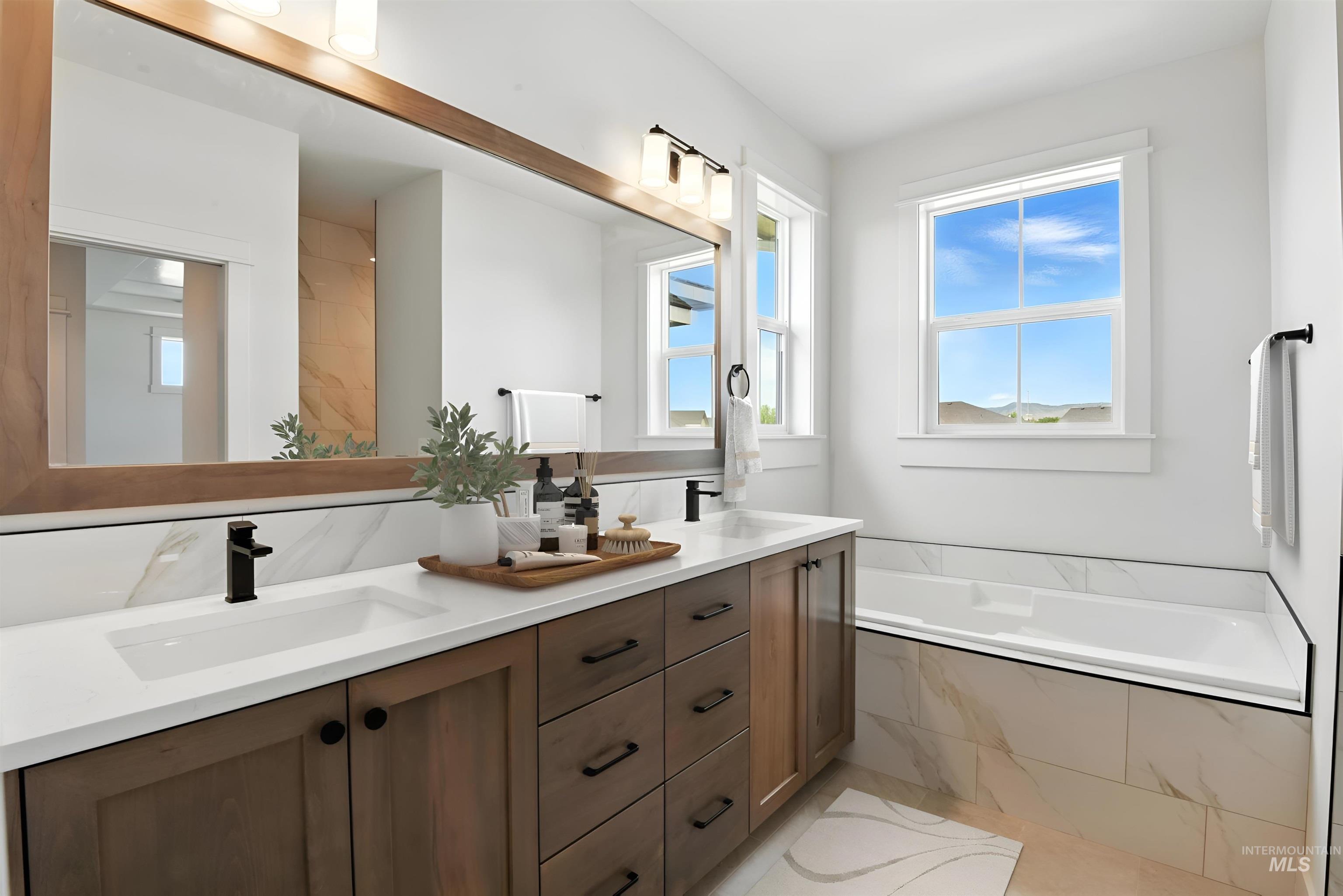 Full bath featuring double vanity and a garden tub