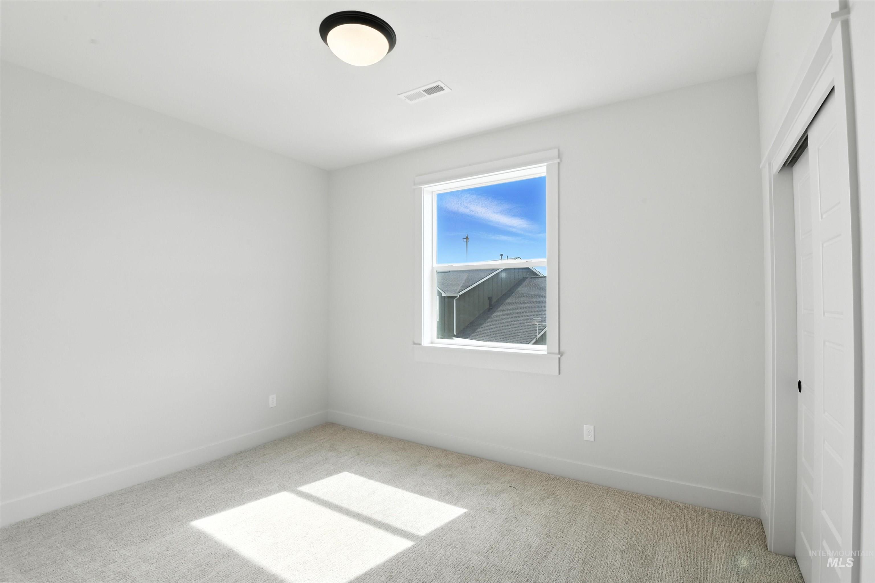 Unfurnished bedroom featuring carpet and a closet