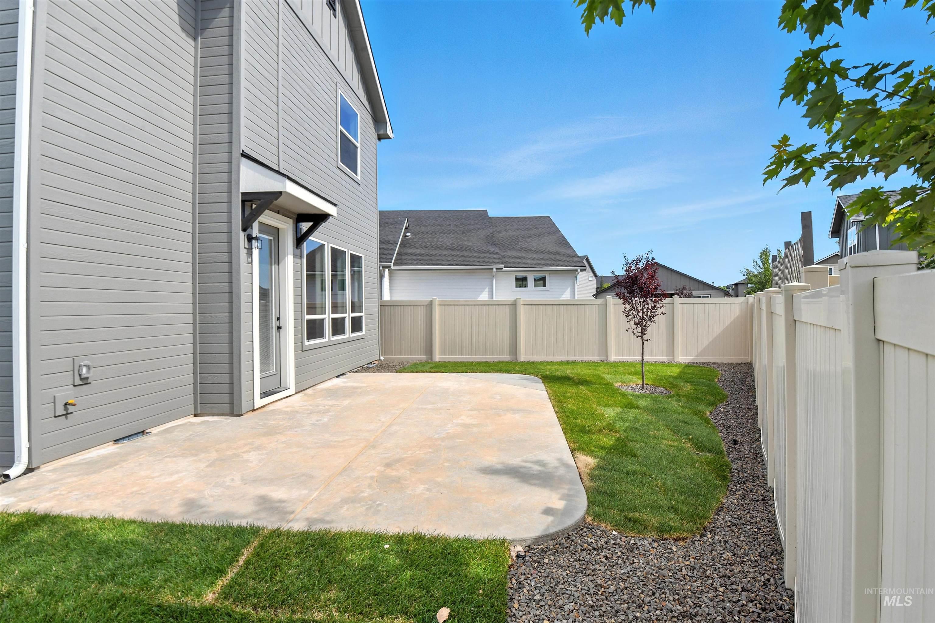 Fenced backyard with a patio