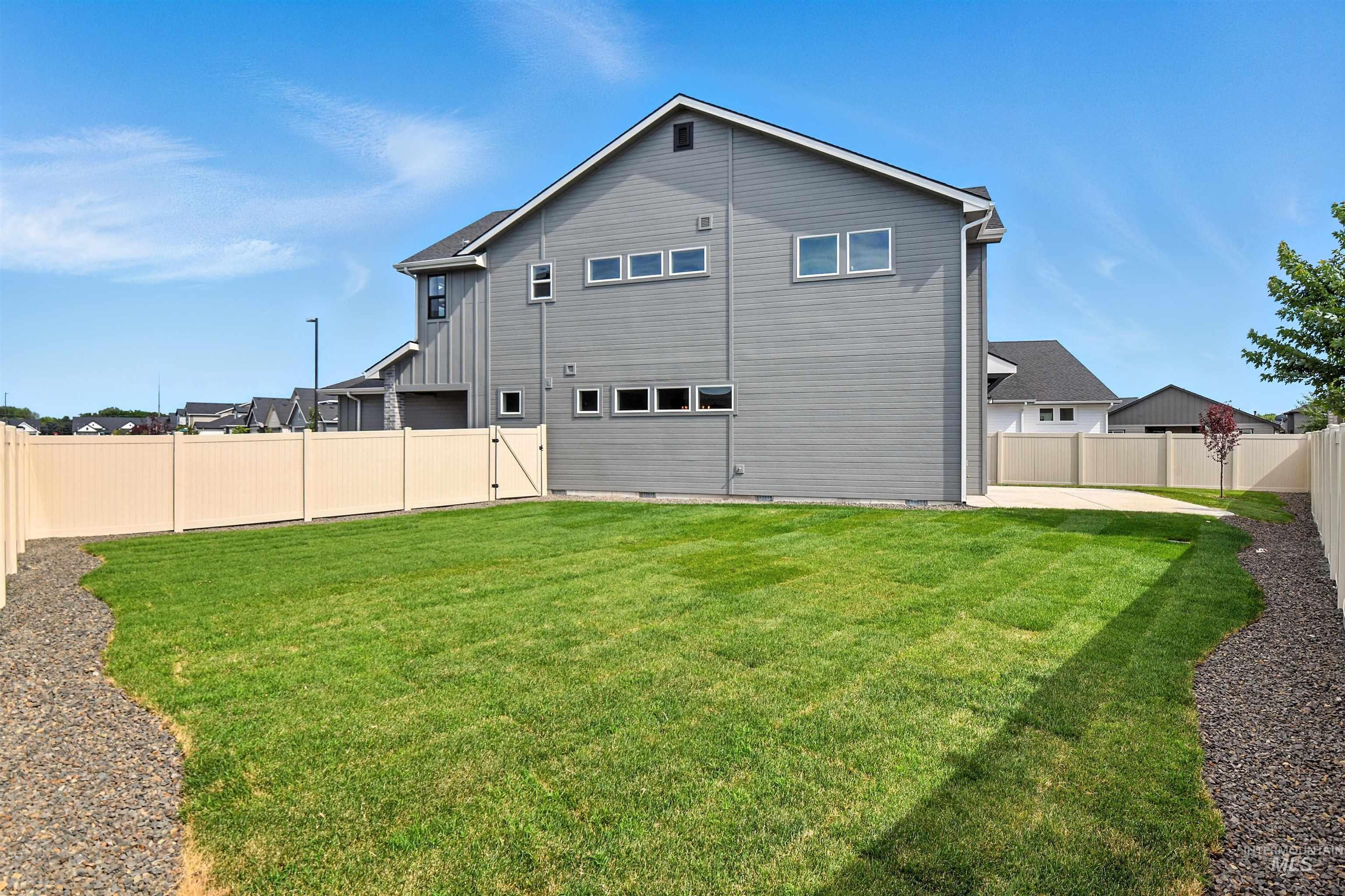 Rear view of property with a fenced backyard, crawl space, and board and batten siding