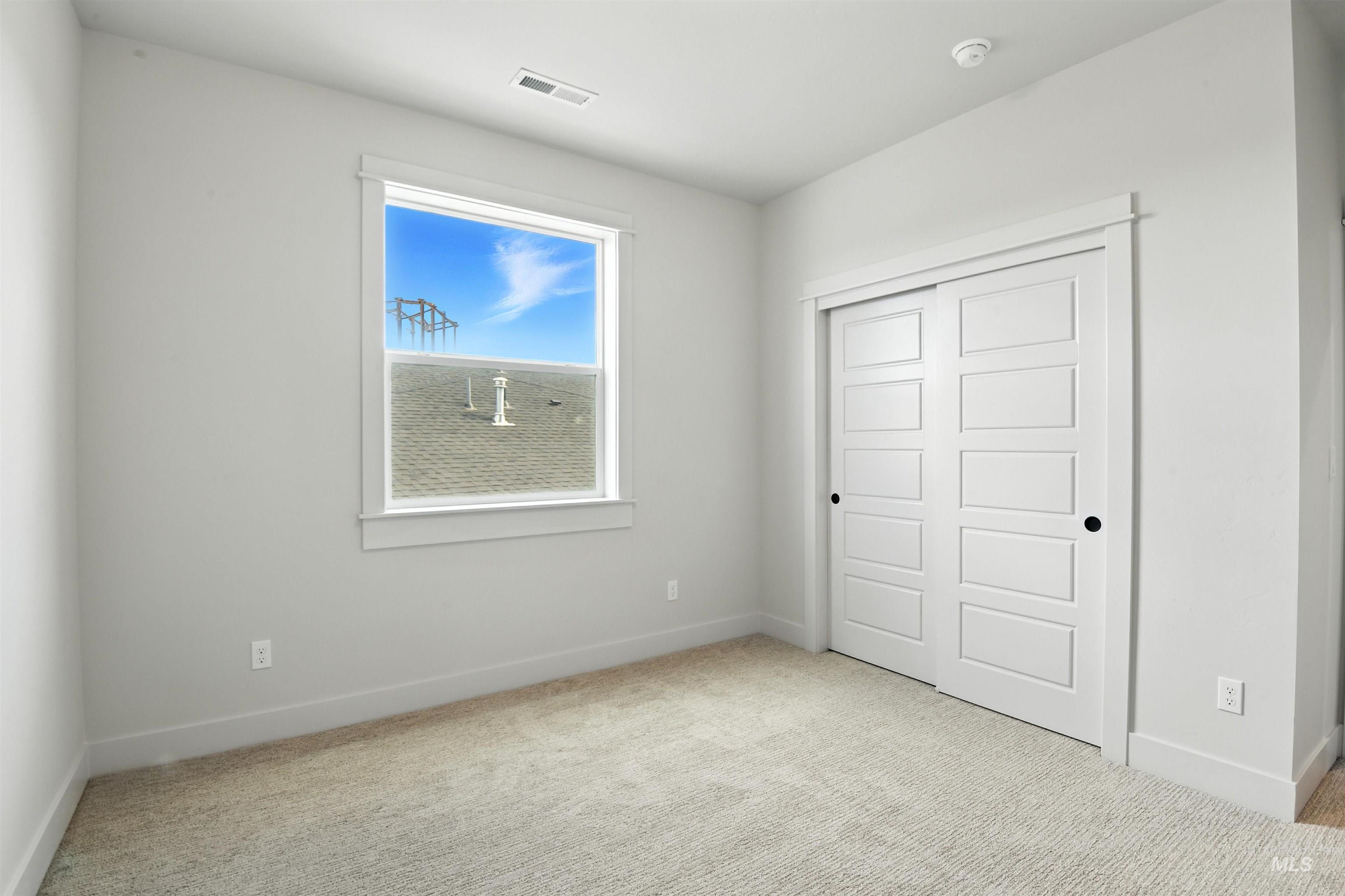 Unfurnished bedroom with carpet and a closet