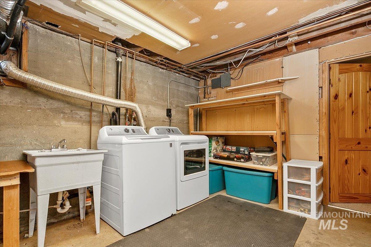 Laundry room with concrete flooring and independent washer and dryer