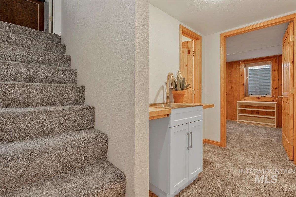 Stairs with carpet flooring and baseboards