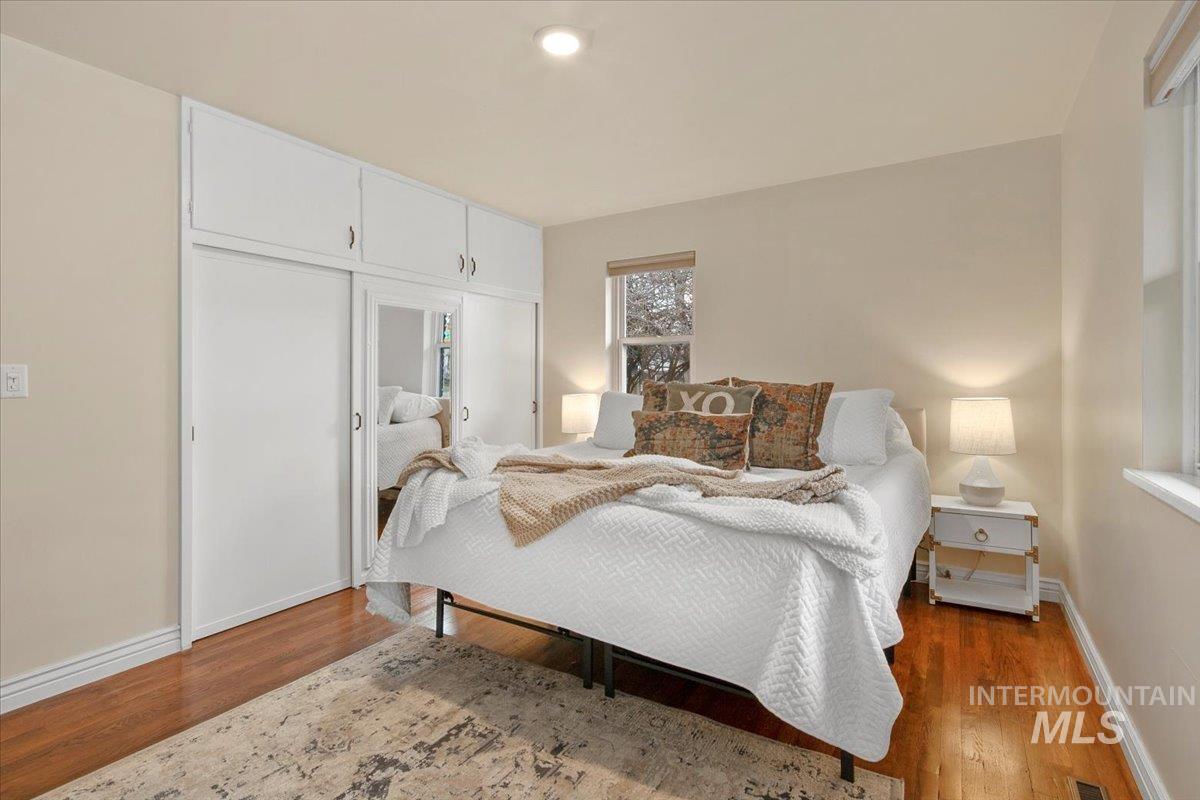 Bedroom with a closet and wood finished floors