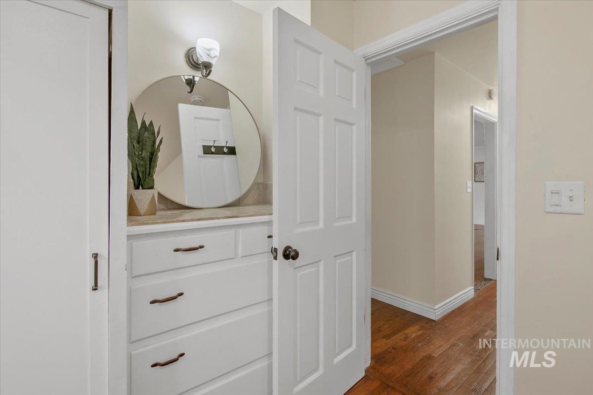 Corridor with baseboards and dark wood finished floors