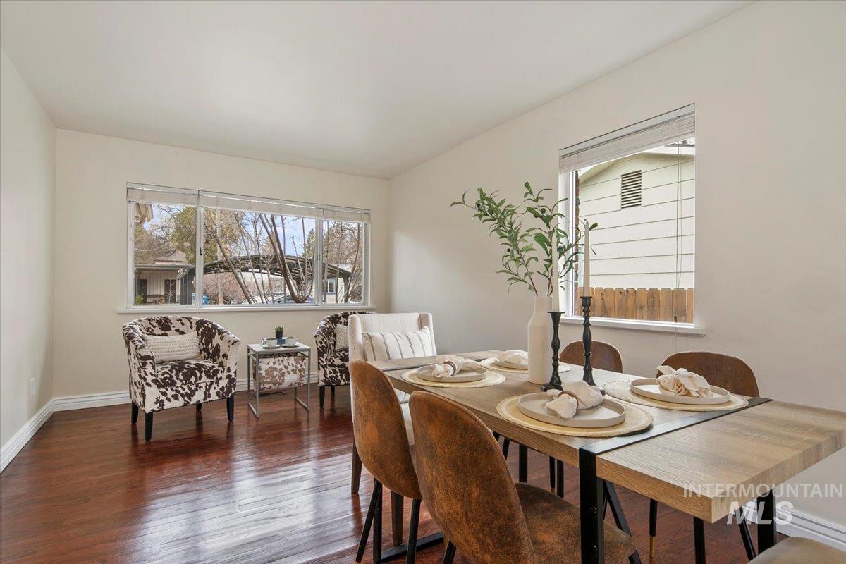 Dining space with dark wood finished floors and baseboards