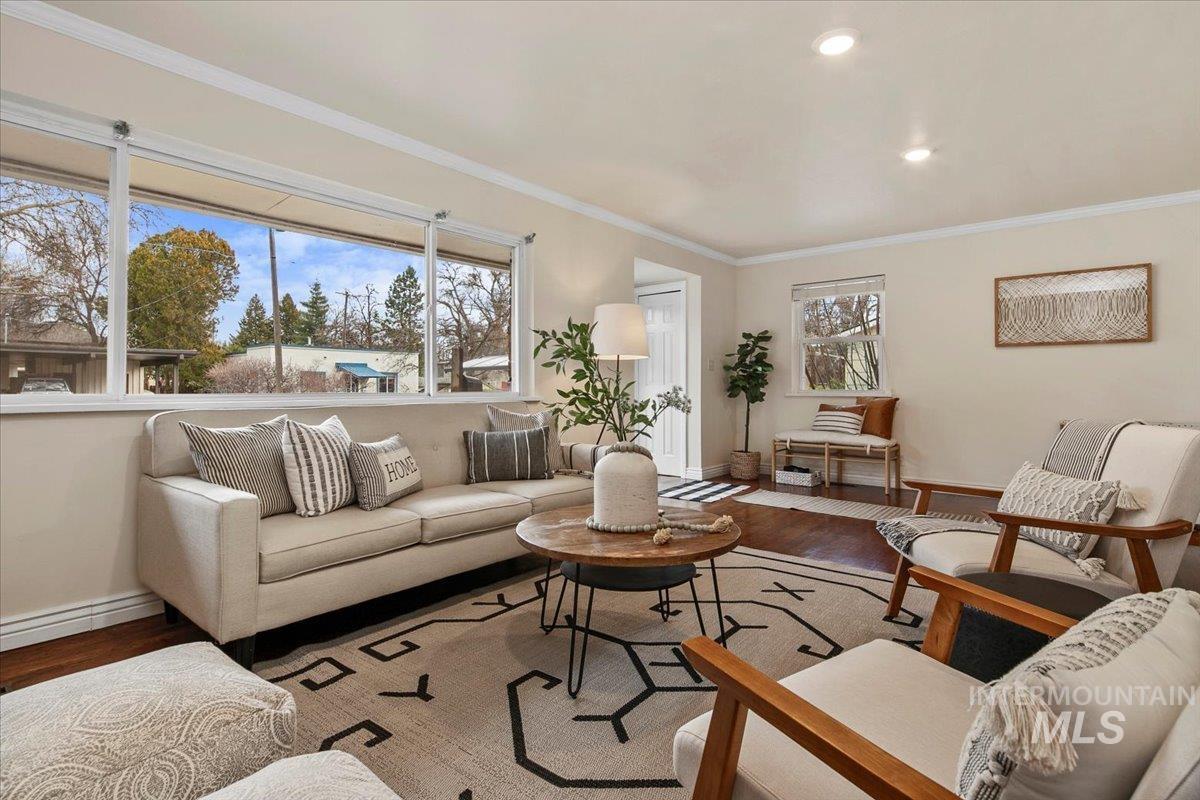 Living area featuring ornamental molding, wood finished floors, and recessed lighting