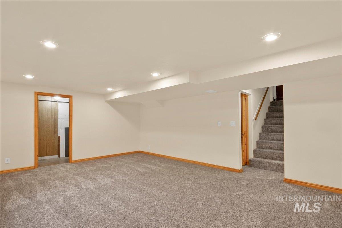 Finished below grade area featuring recessed lighting, carpet, and stairway