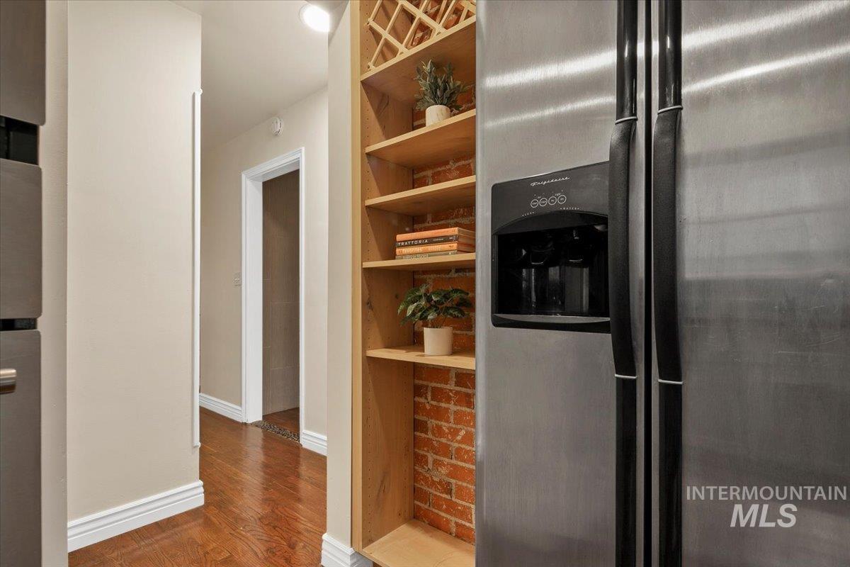 Kitchen with stainless steel fridge with ice dispenser and wood finished floors