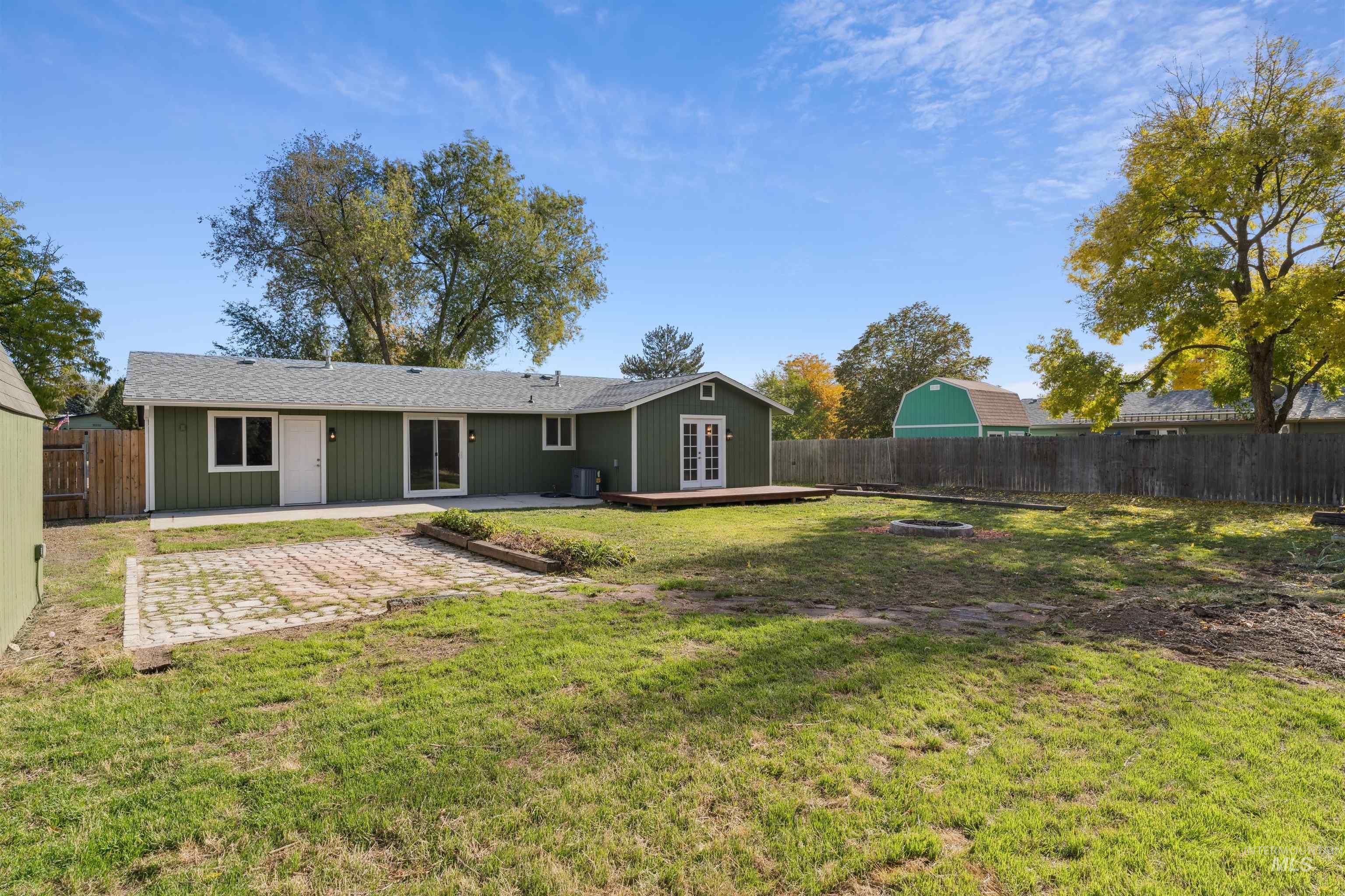 Rear view of house featuring a fenced backyard, a patio, and french doors
