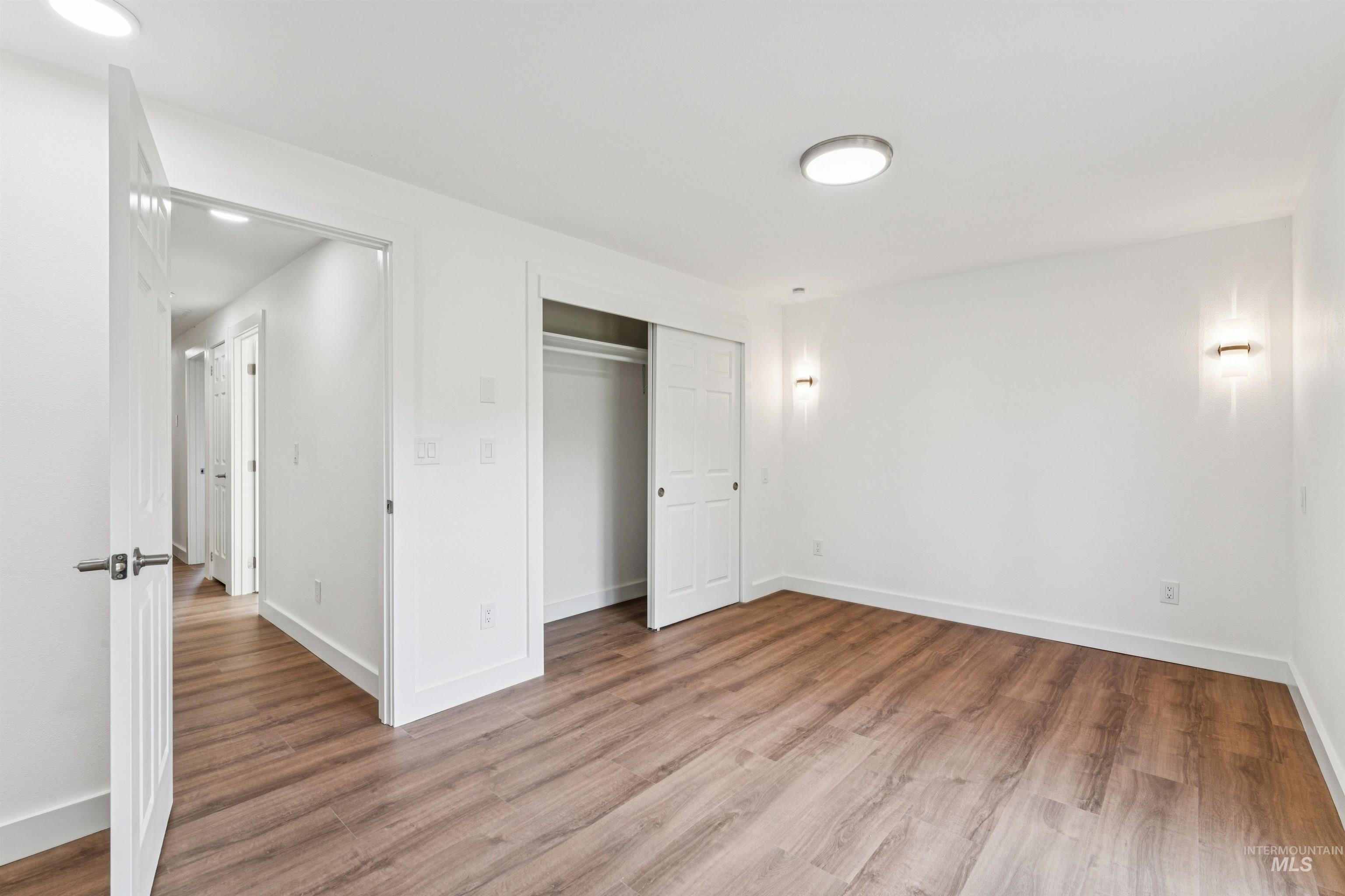 Unfurnished bedroom with light wood finished floors and a closet