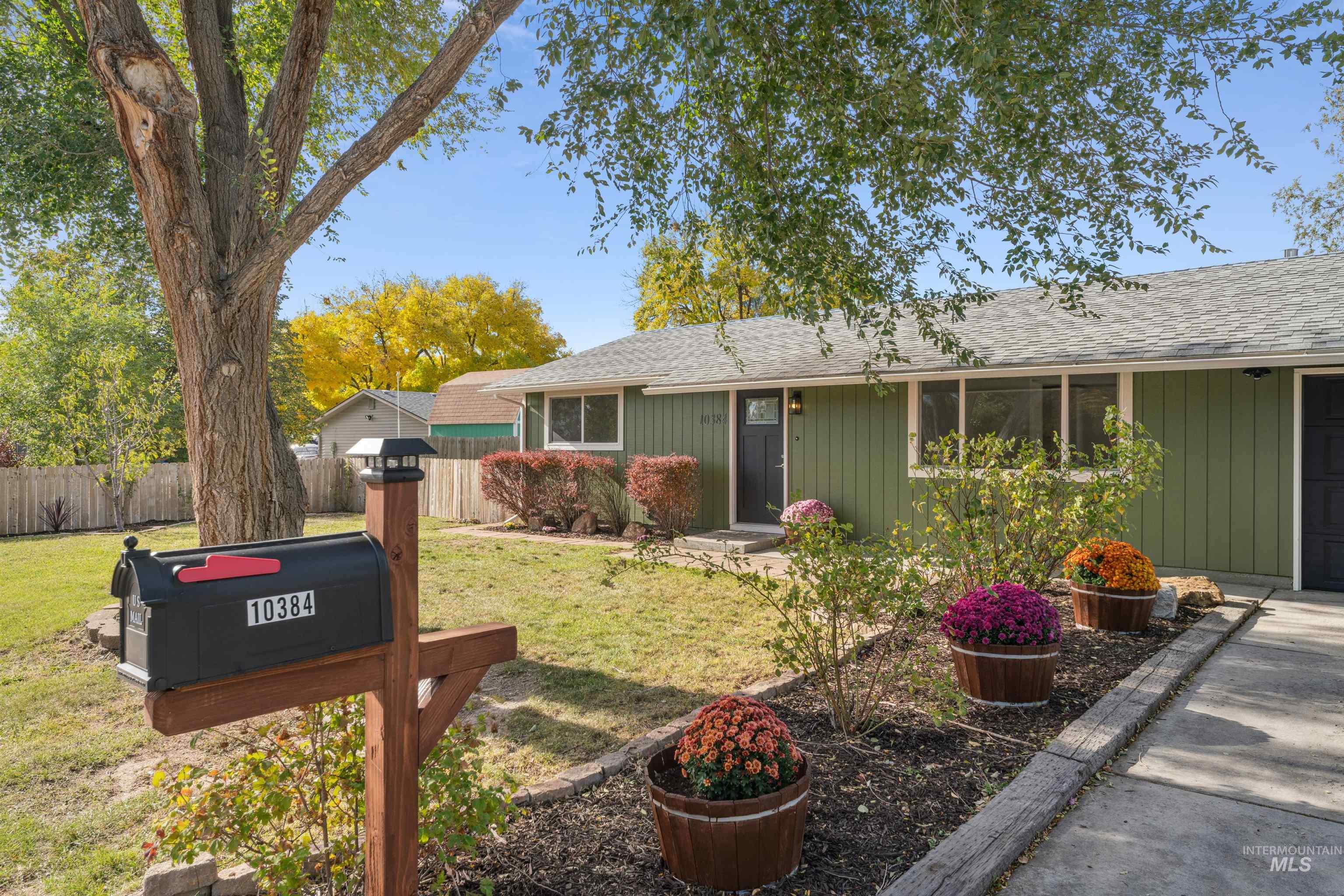 View of front of home with roof with shingles and an attached garage