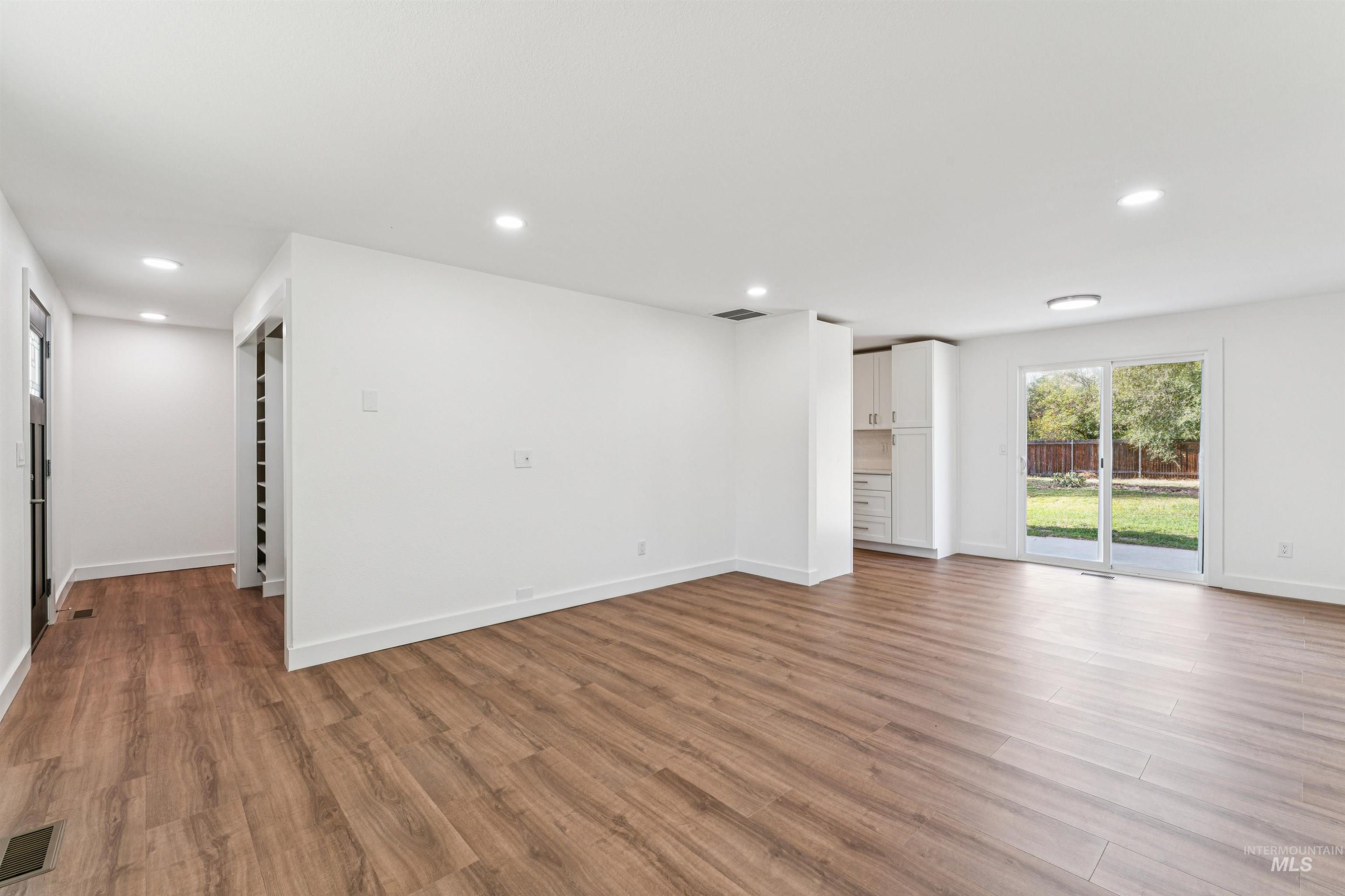 Unfurnished living room featuring light wood-style flooring and recessed lighting