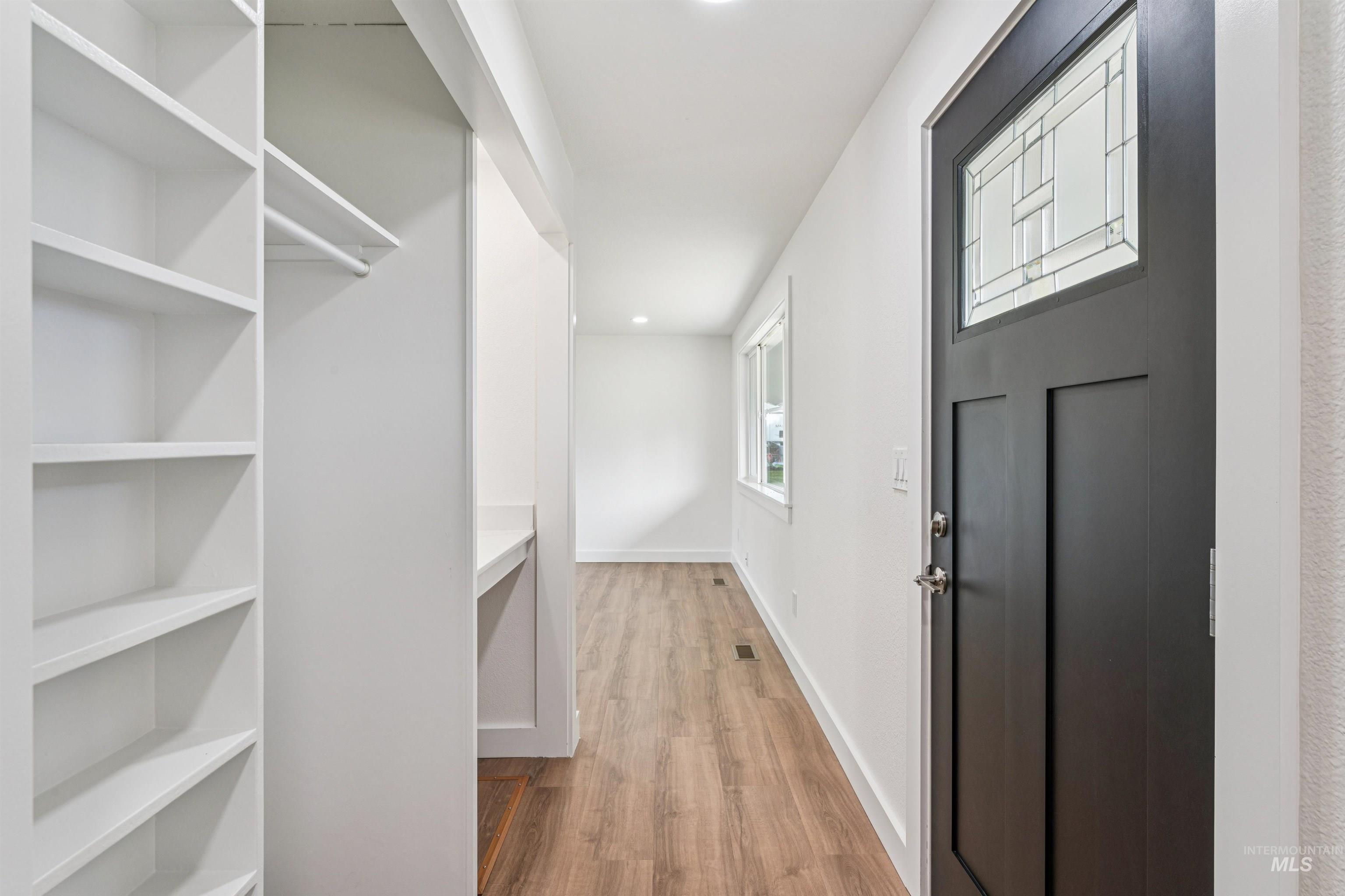 Walk in closet featuring light wood finished floors