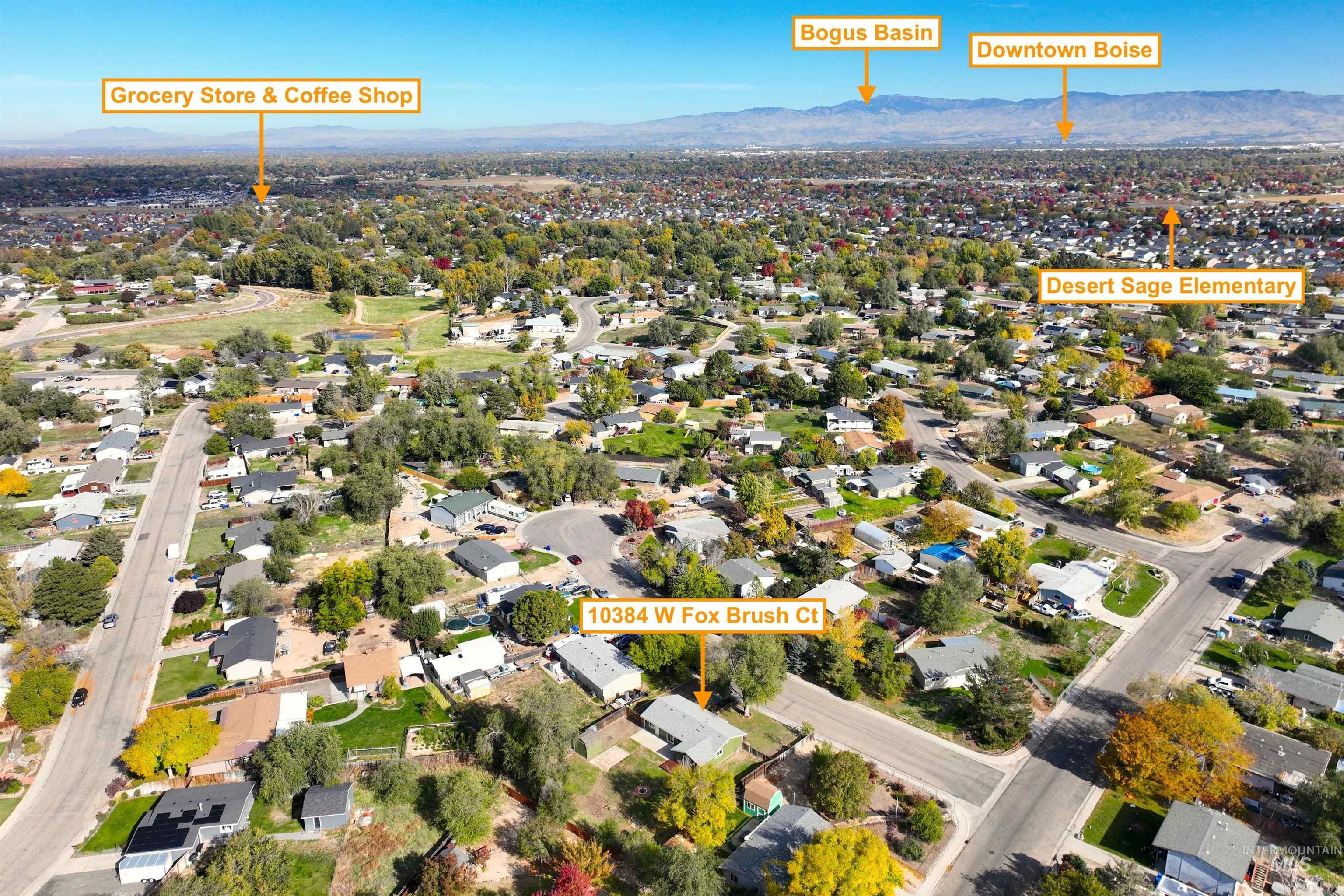 Aerial overview of property's location featuring nearby suburban area and mountains