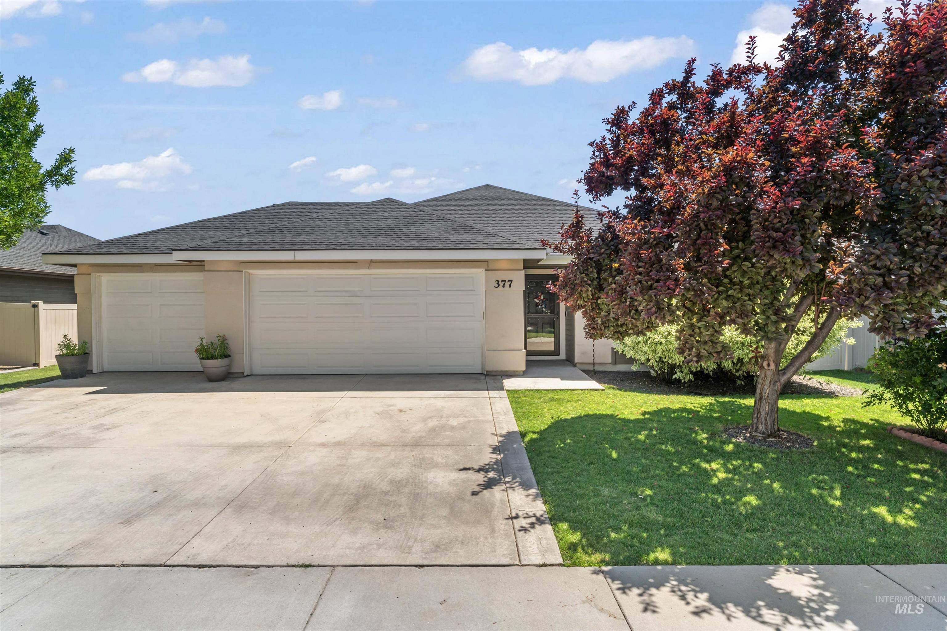 View of front of home featuring a garage, driveway, stucco siding, and a shingled roof