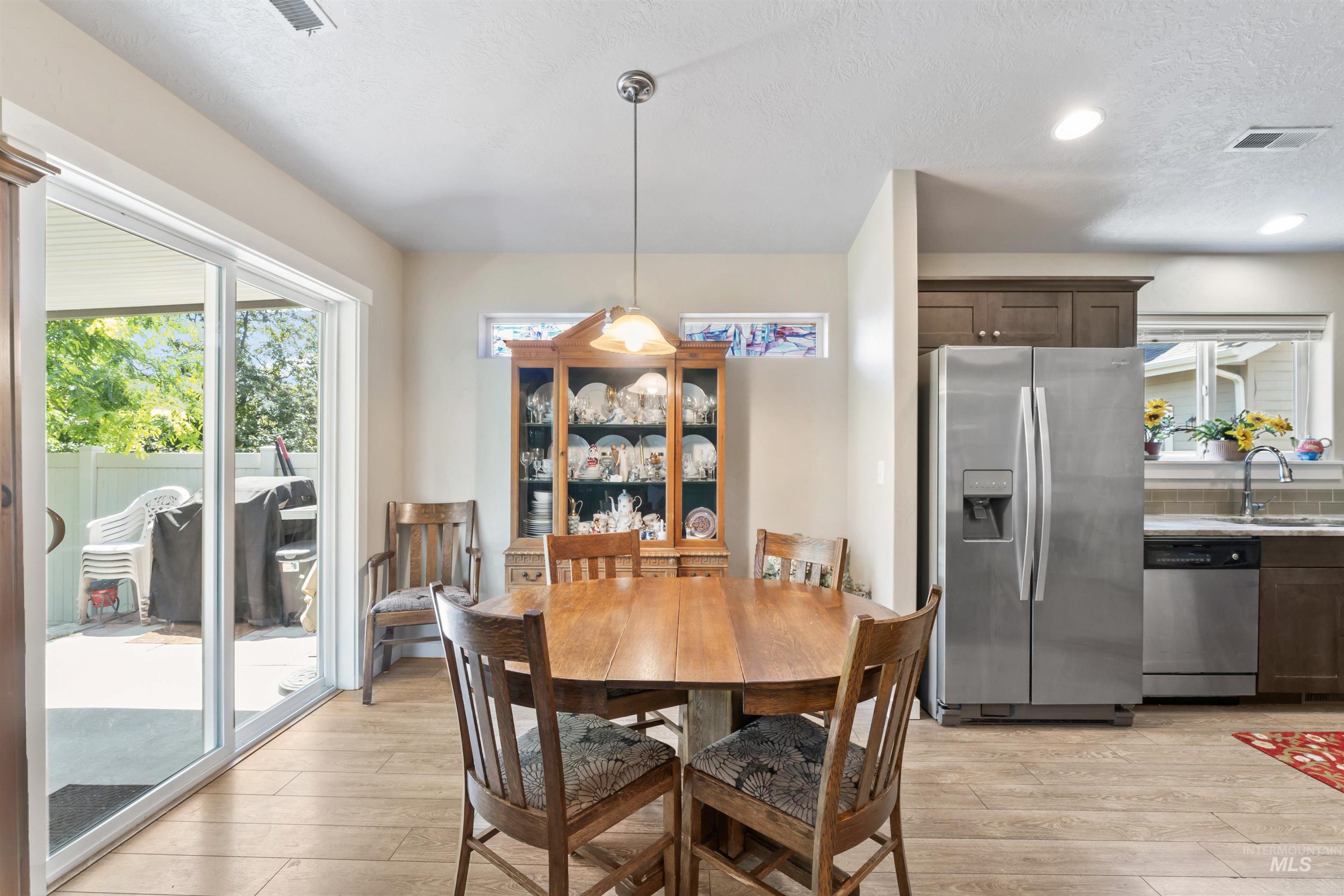Dining space featuring light wood finished floors and recessed lighting