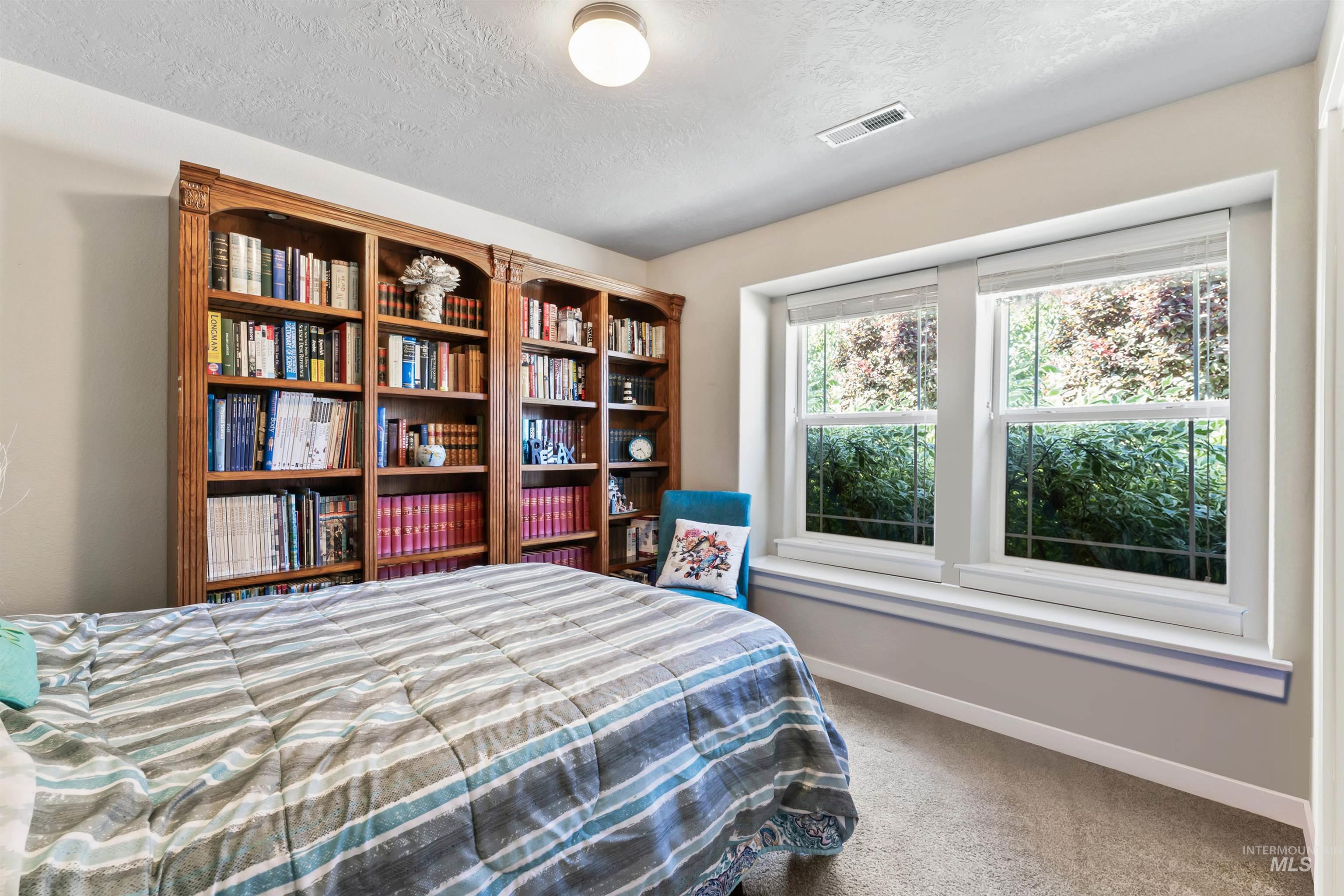 Bedroom featuring a textured ceiling and carpet