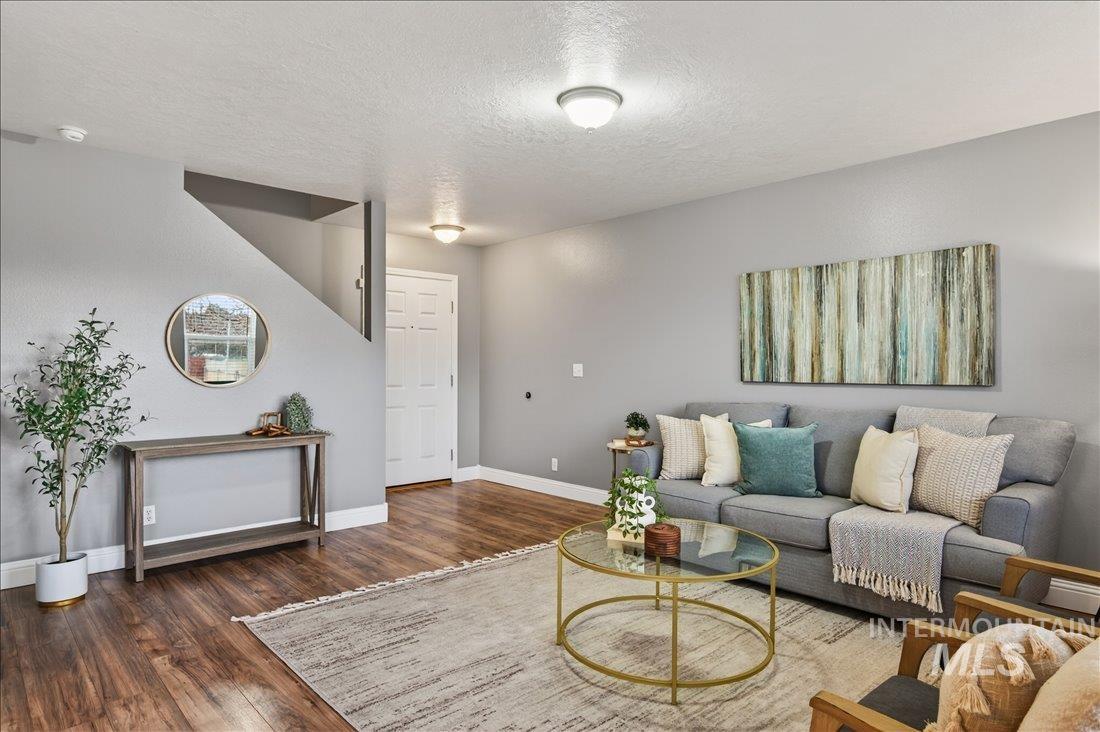 Living room with a textured ceiling and wood finished floors