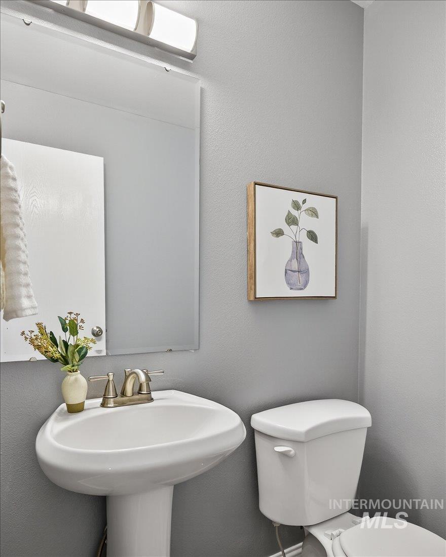 Half bathroom featuring a textured wall