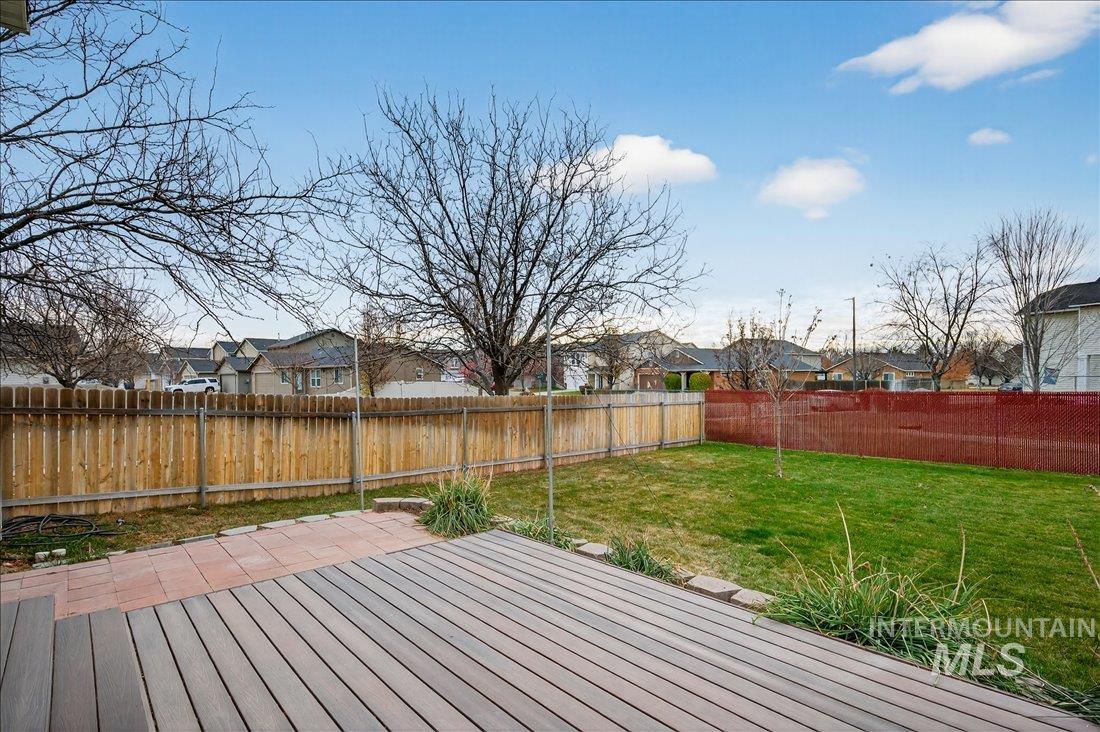 Wooden deck featuring a residential view and a fenced backyard