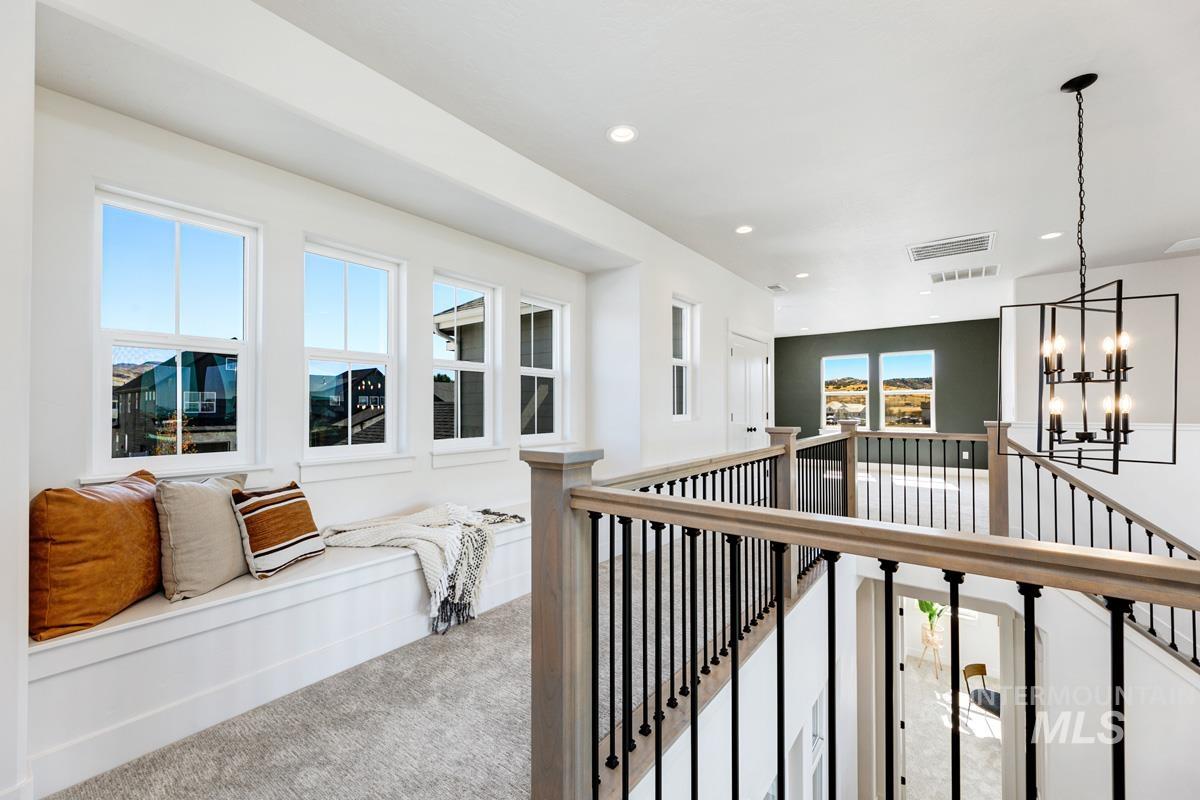 Hall featuring carpet floors, an upstairs landing, and recessed lighting