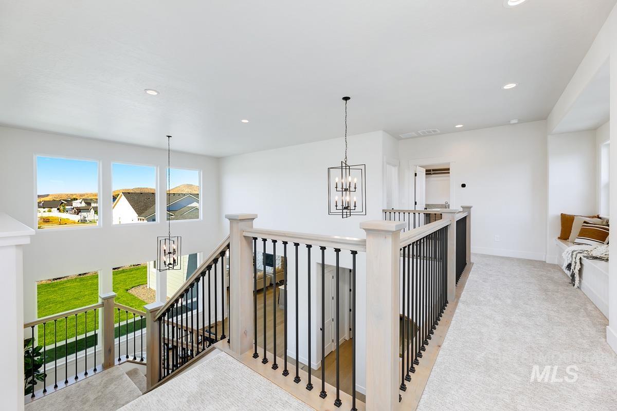 Hallway featuring a chandelier, recessed lighting, an upstairs landing, and carpet floors