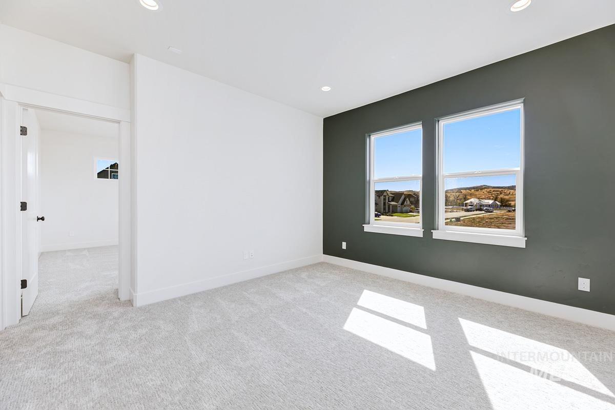 Spare room with light carpet and recessed lighting