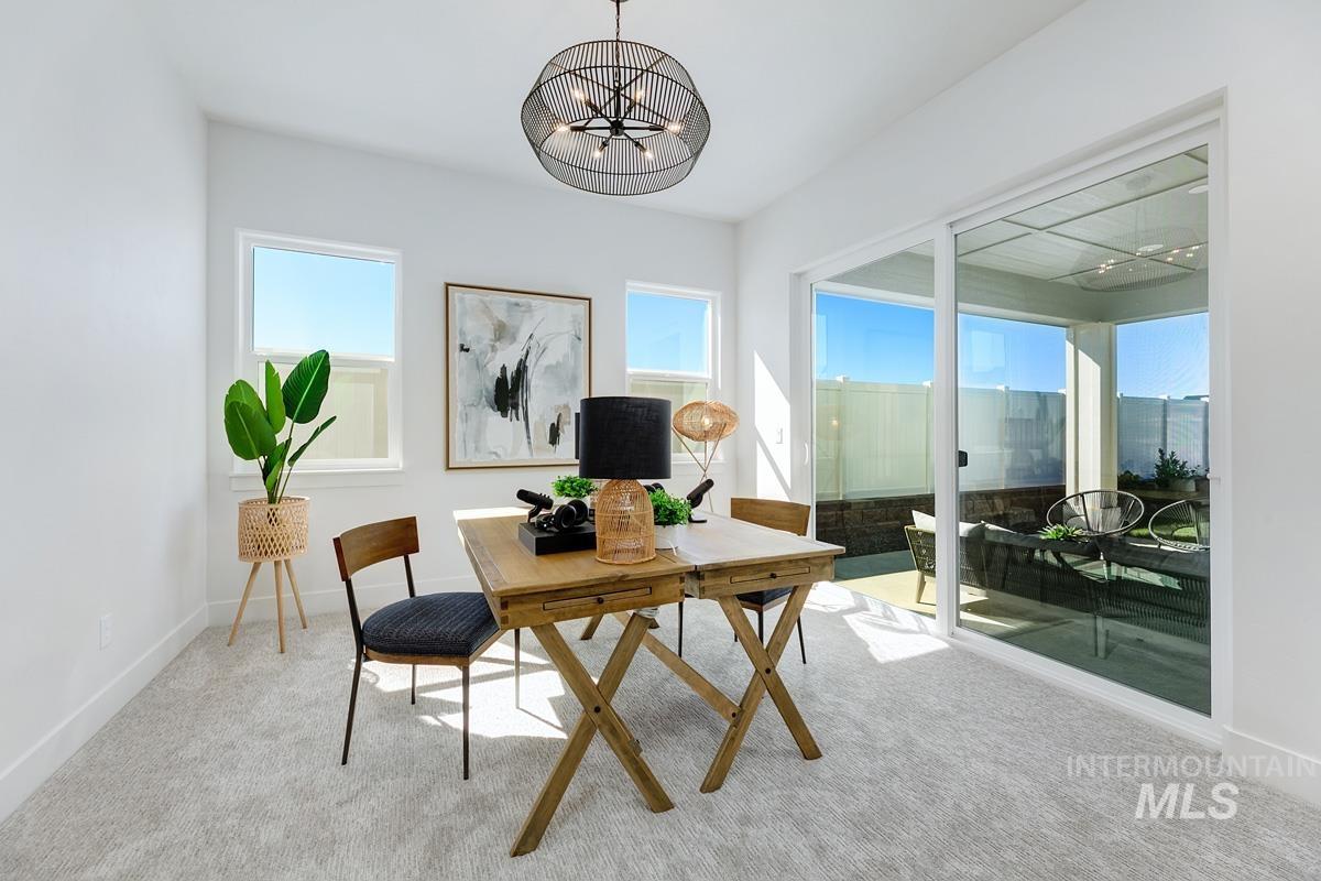 Home office featuring carpet flooring and a chandelier