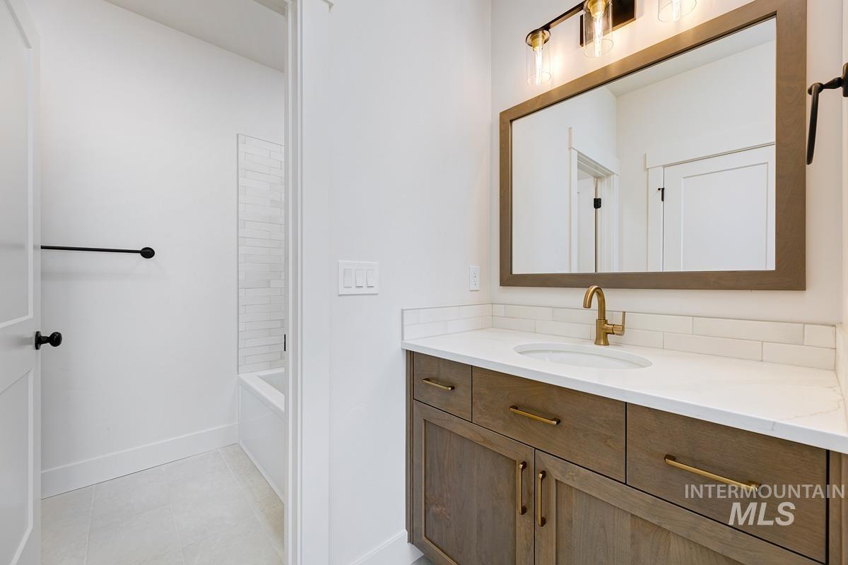 Full bathroom with vanity, tub / shower combination, and light tile patterned floors